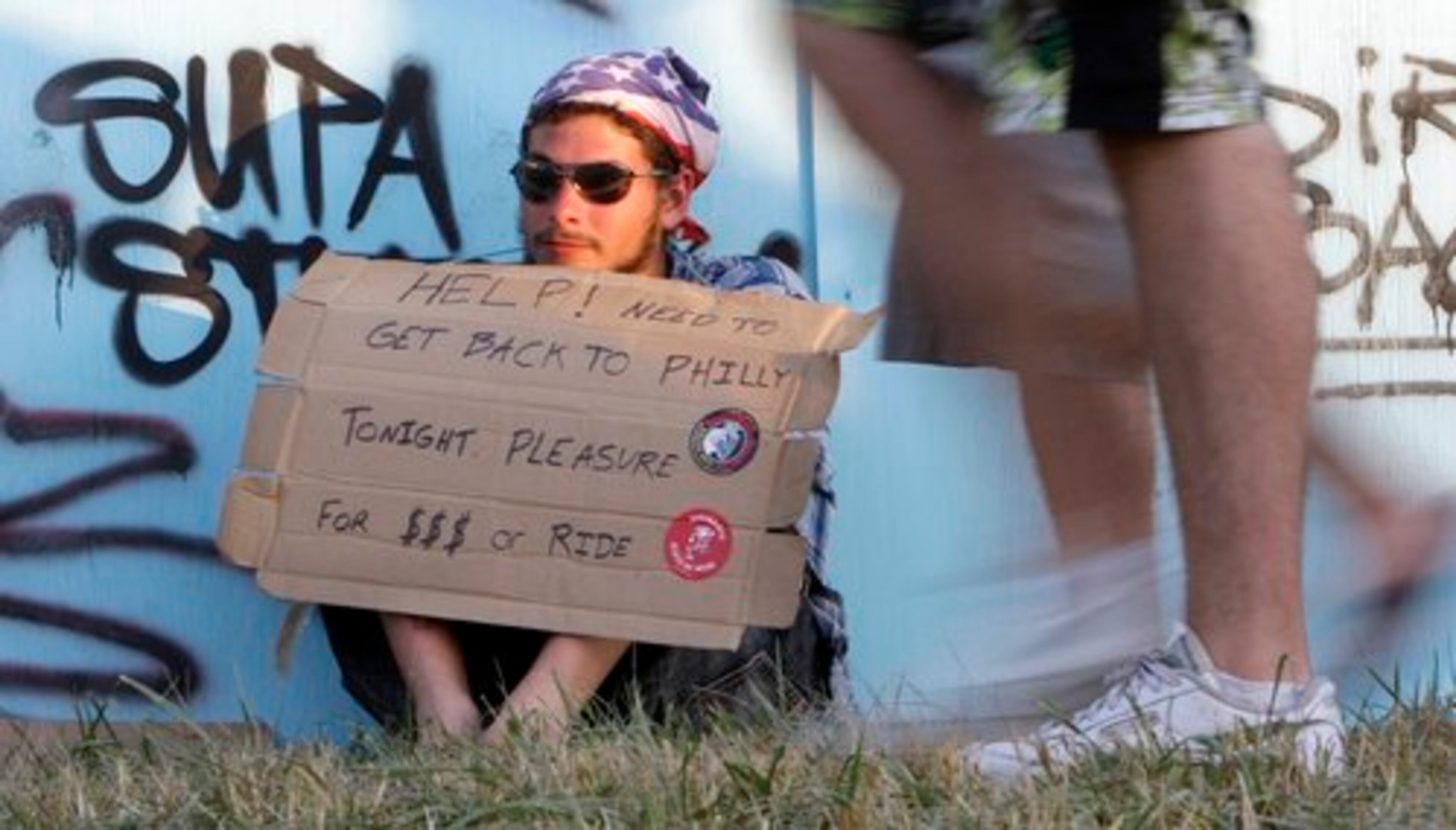 Zachary Hennis, 19, tries to get help in getting home to Philadelphia on the last day of the Bonnaroo music festival Sunday. Hennis drove to Manchester, Tenn. with two friends, but their car broke down when they arrived last week.