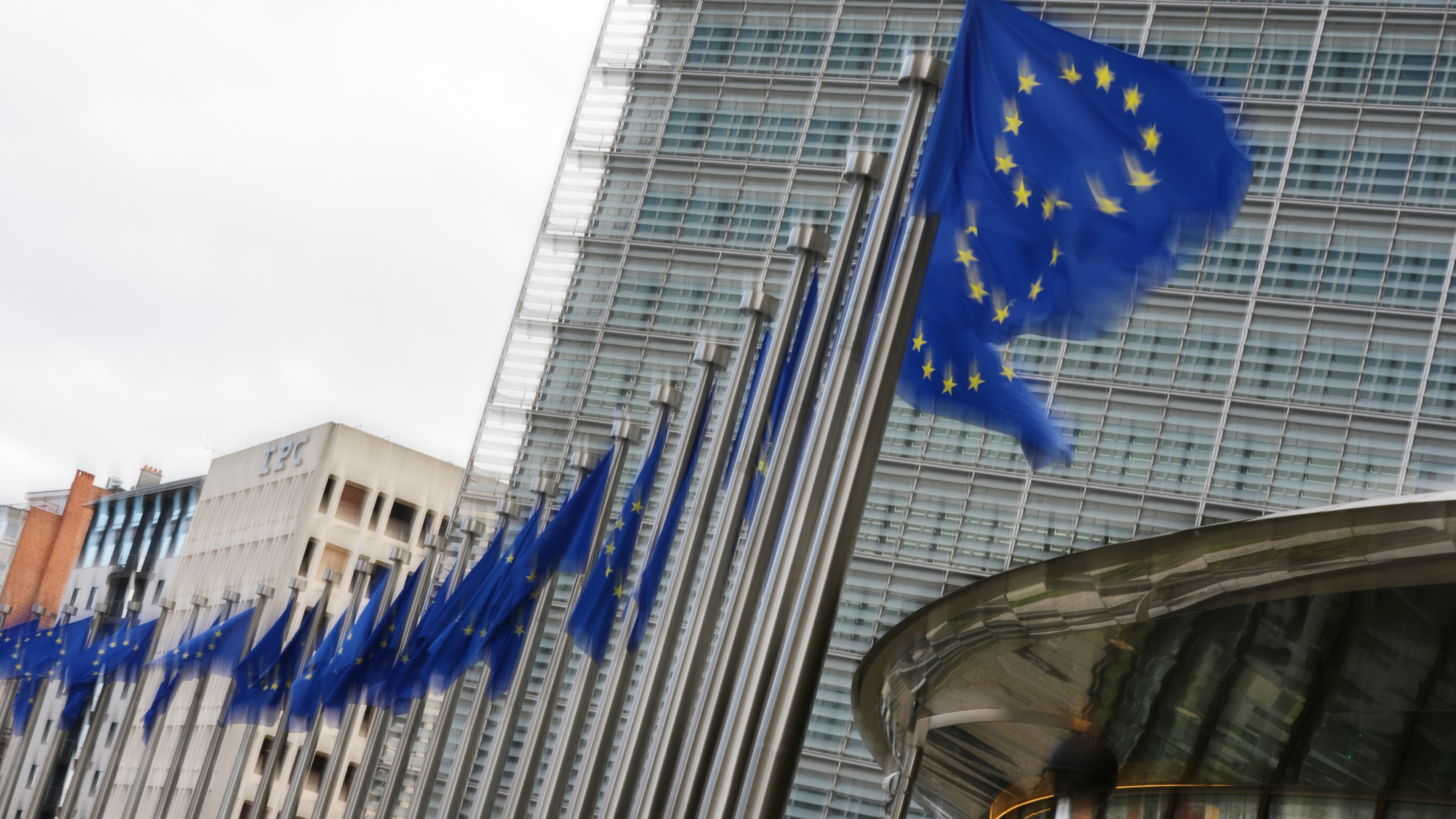 European Union flags flap in the wind outside EU headquarters in Brussels, Tuesday, May 12, 2026. (AP Photo/Virginia Mayo)
