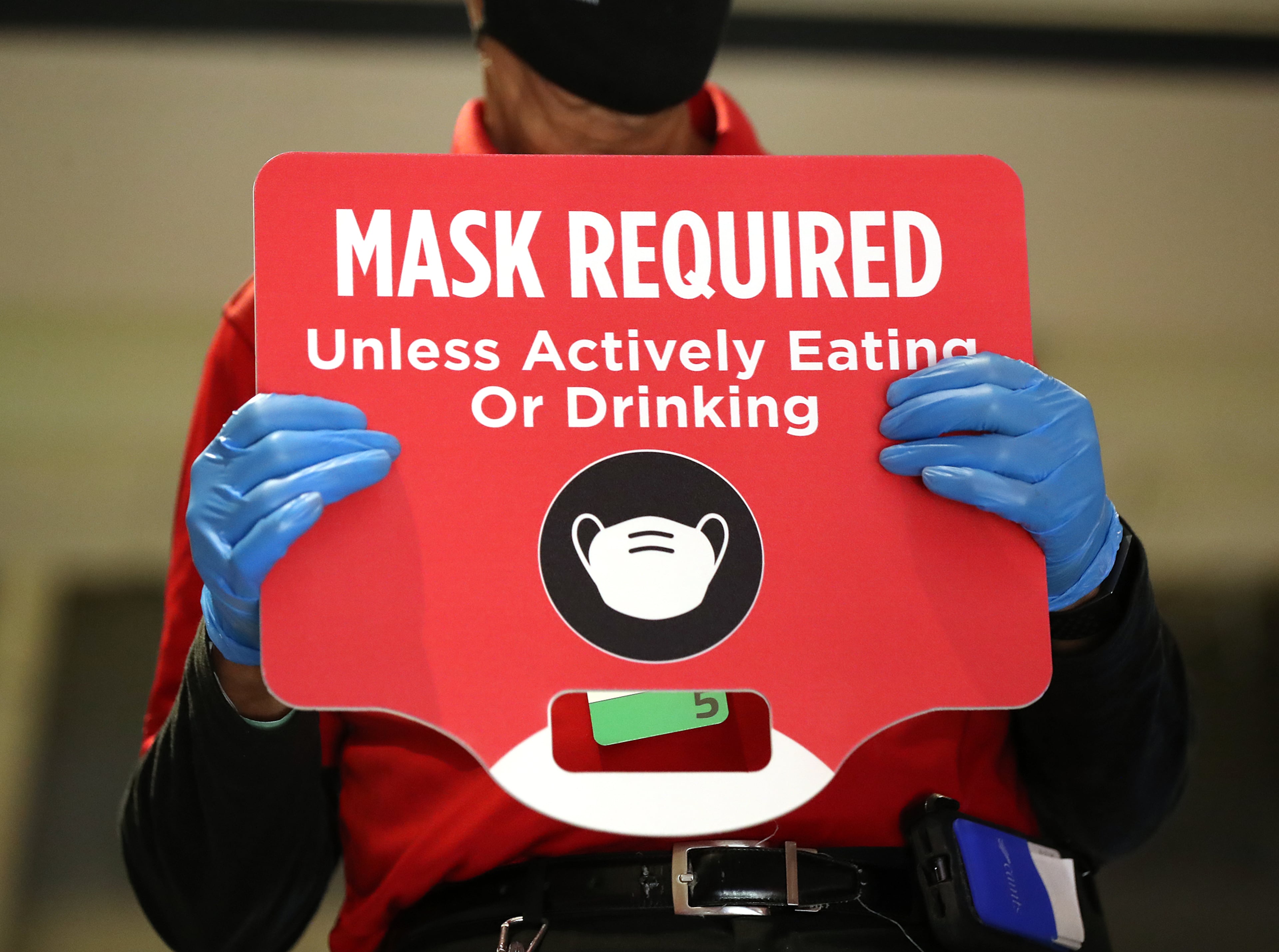 A Hawks usher holds a sign requiring masks for the game against the Los Angeles Clippers in an NBA basketball game on Tuesday, Jan. 26, 2021, in Atlanta. Curtis Compton / Curtis.Compton@ajc.com”