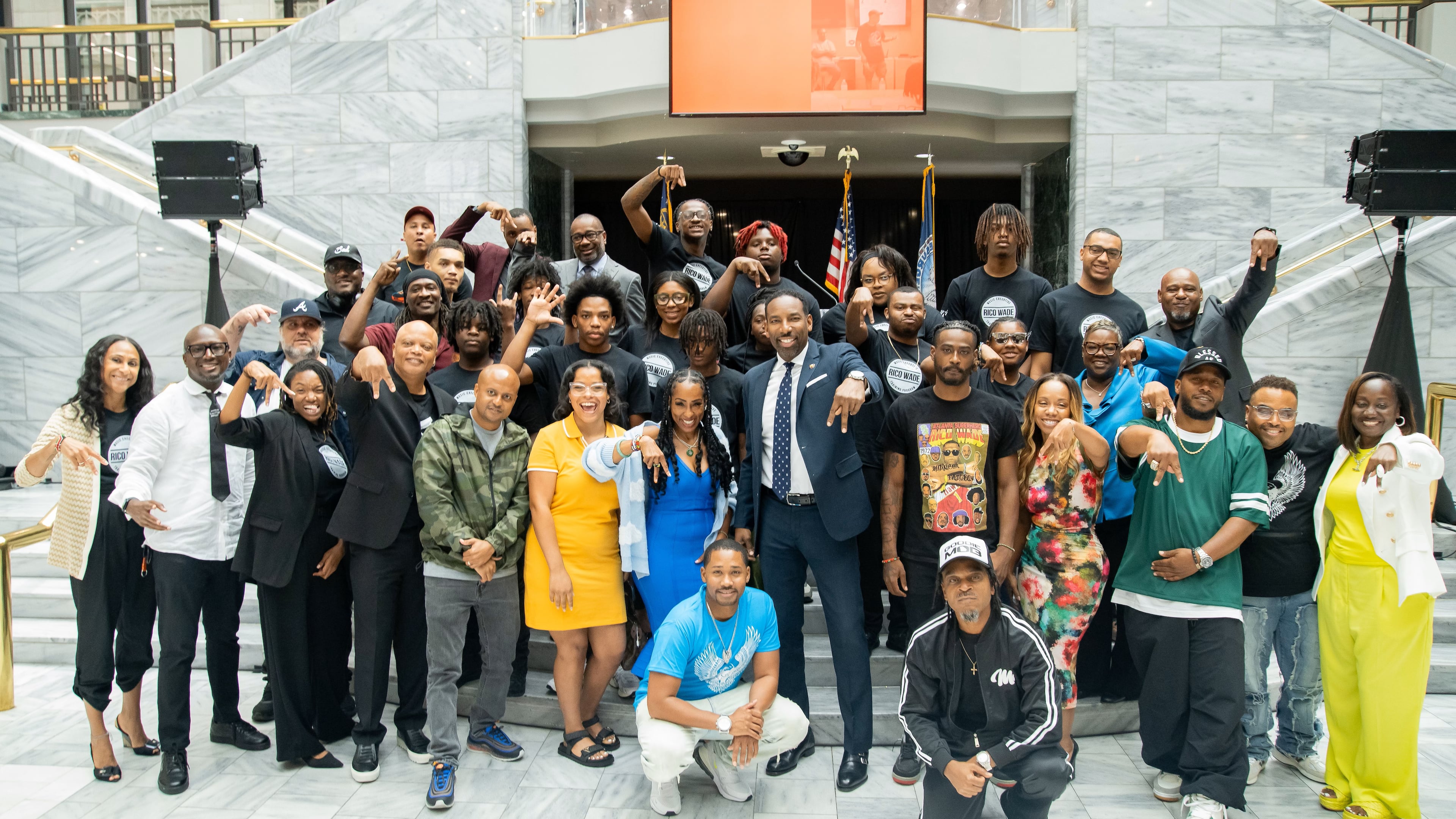 The graduates of the Rico Wade Music Executive Training Program gather for a group photo in City Hall with top music executives and guest speakers of the program on July 29, 2024.