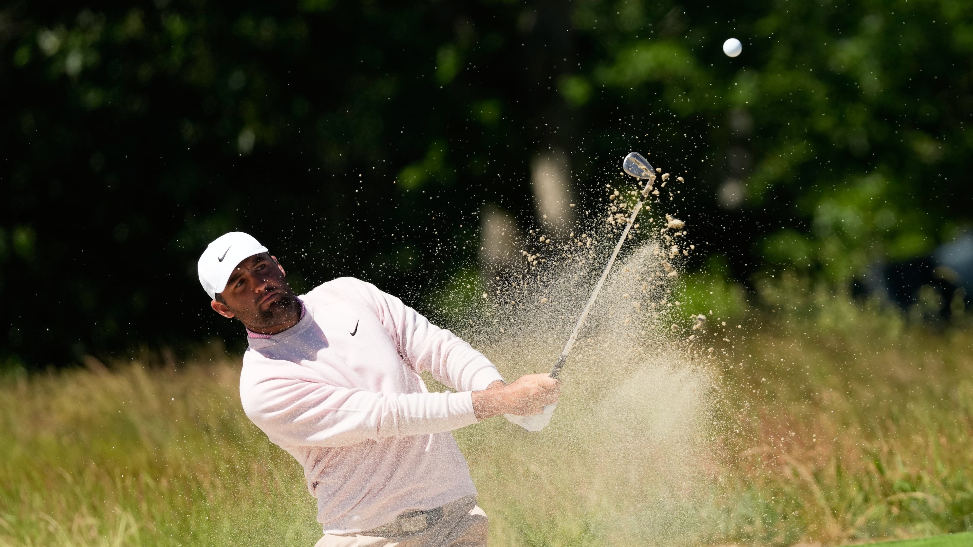 Scottie Scheffler hits from the bunker on the second hole during a practice round for the U.S. Open golf tournament at Shinnecock Hills Golf Club in Southampton, N.Y., Tuesday, June 16, 2026.(AP Photo/David J. Phillip)