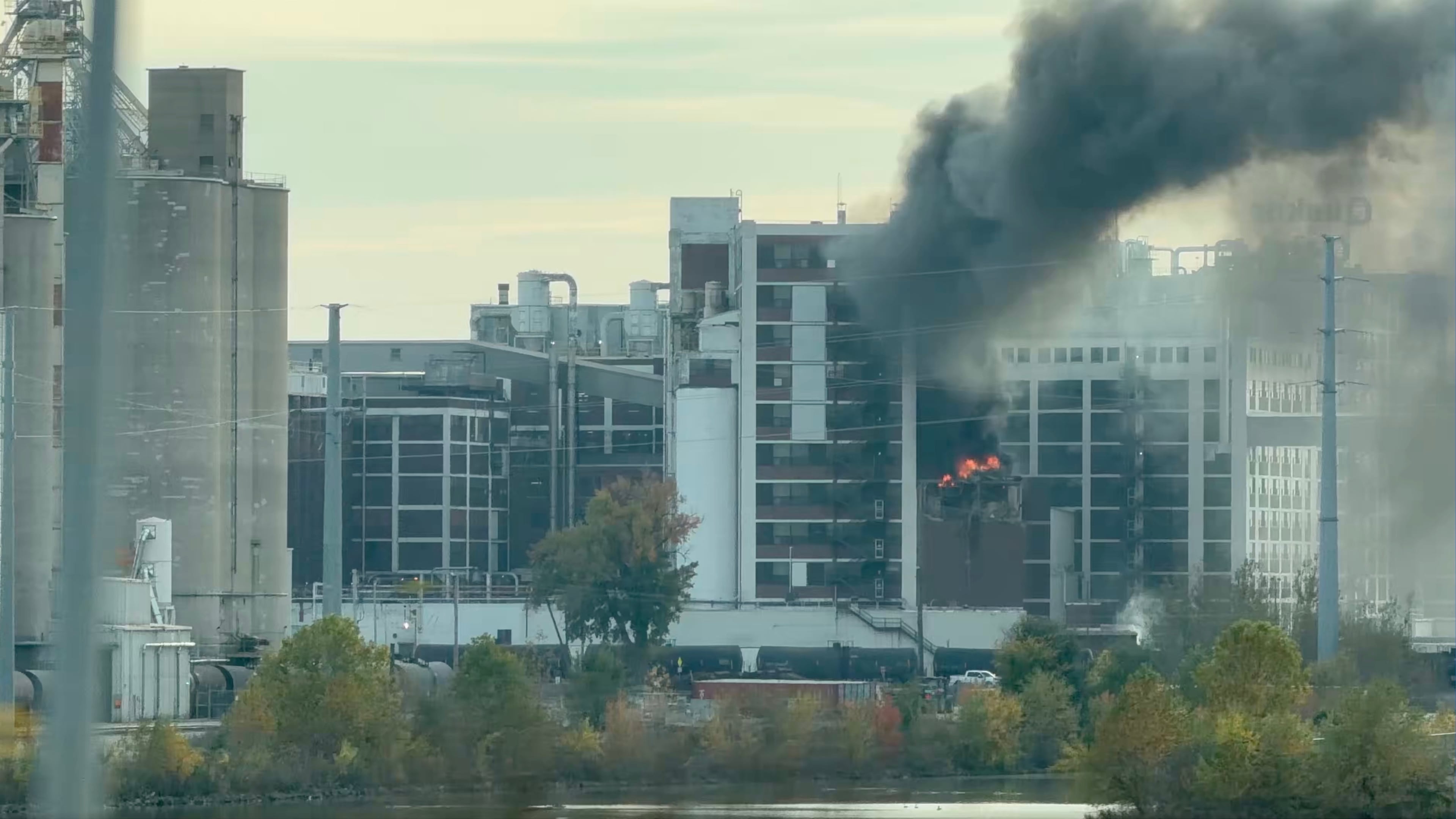 In this image from video, fire and smoke rise from a building attached to Quaker Oats facility in Cedar Rapids, Iowa. (Brian Owens via AP)