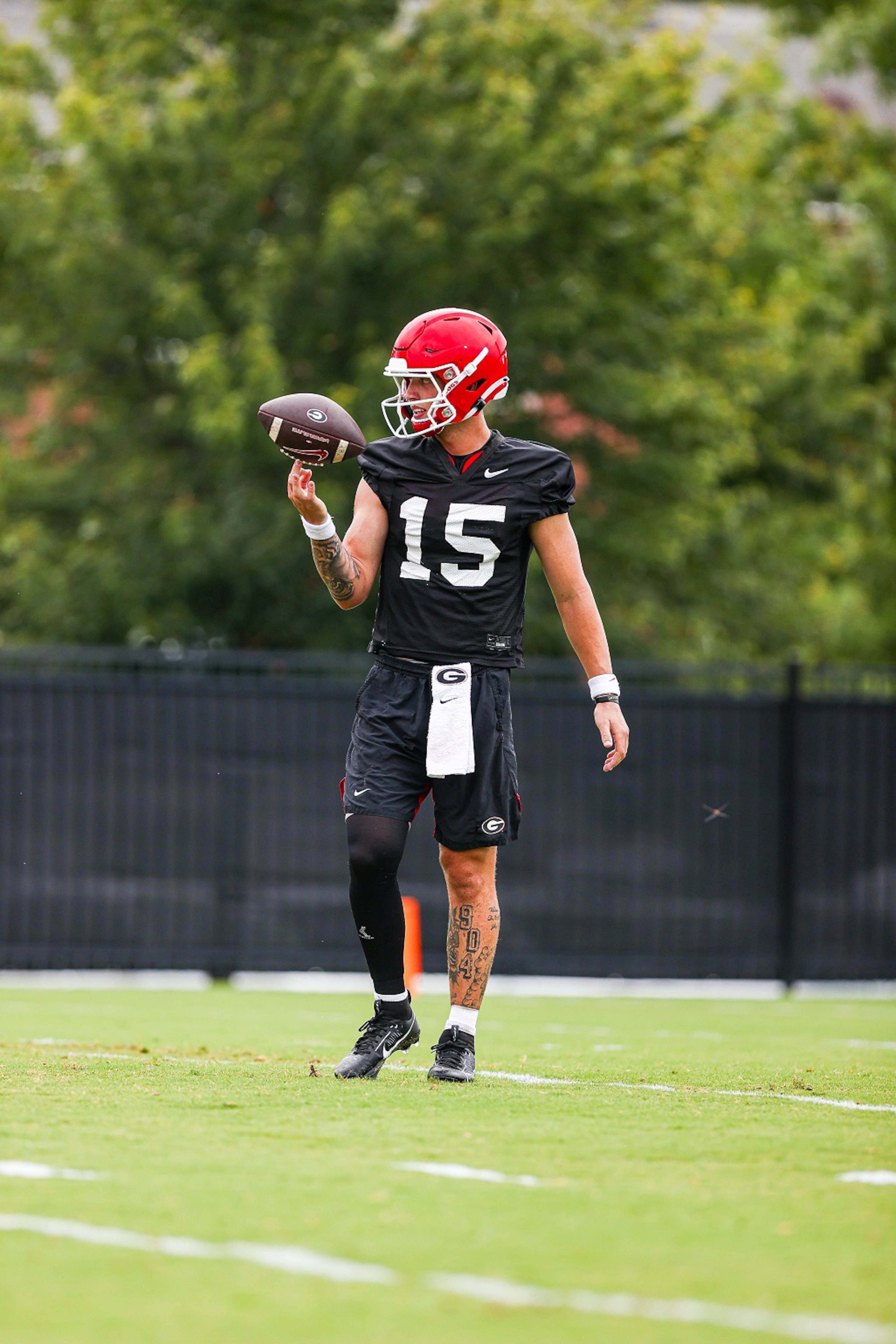 Georgia quarterback Carson Beck balances a football during Georgia’s practice session in Athens, Ga., on Thursday, Aug. 3, 2023. (Tony Walsh/UGAAA)