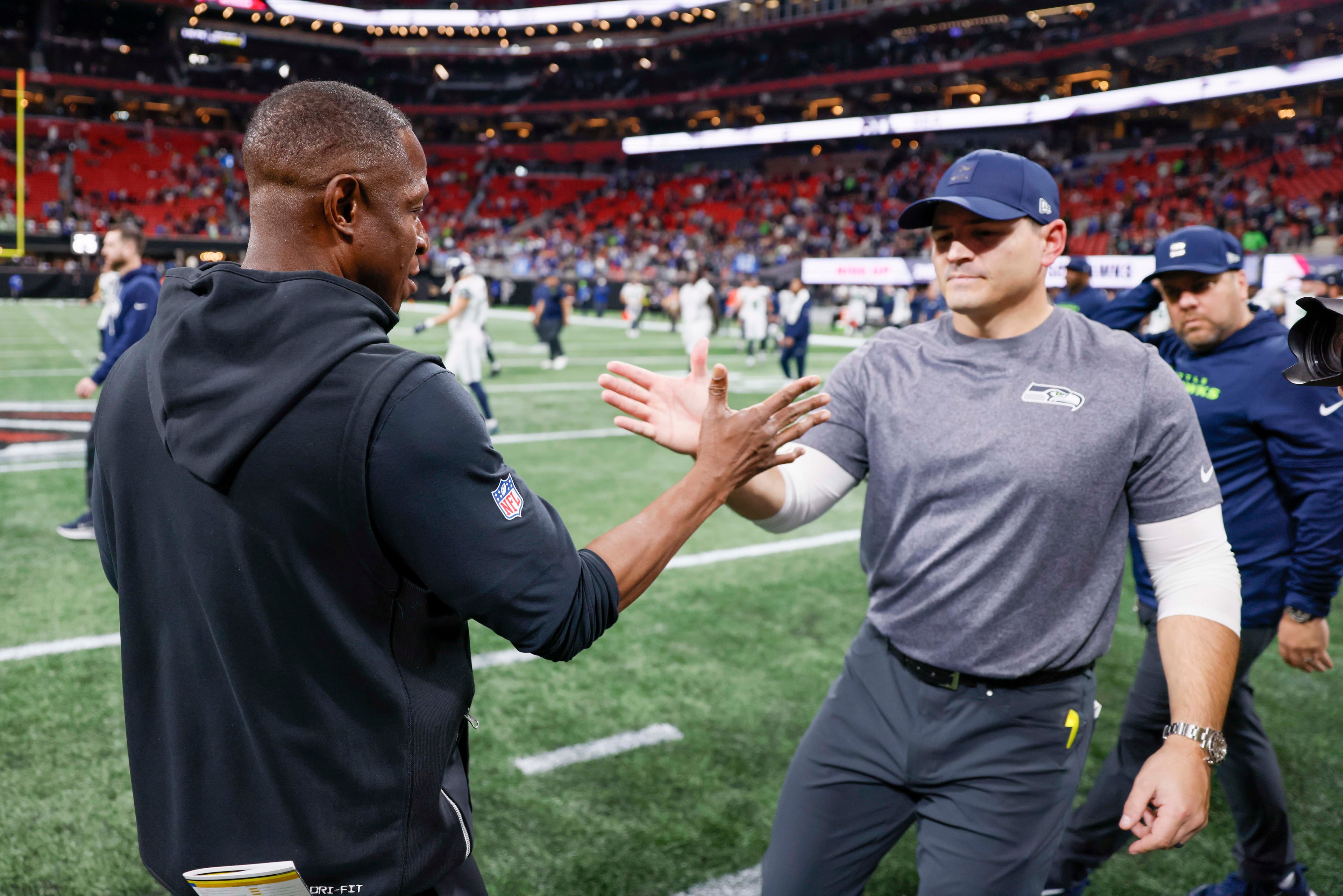 Atlanta Falcons head coach Raheem Morris shakes hands with Seattle Seahawks head coach Mike MacDonald after the game, in which the Seahawks defeated the Falcons 37-9 at Mercedes-Benz Stadium in Atlanta on Sunday, Dec. 7, 2025. (Miguel Martinez/ AJC)
