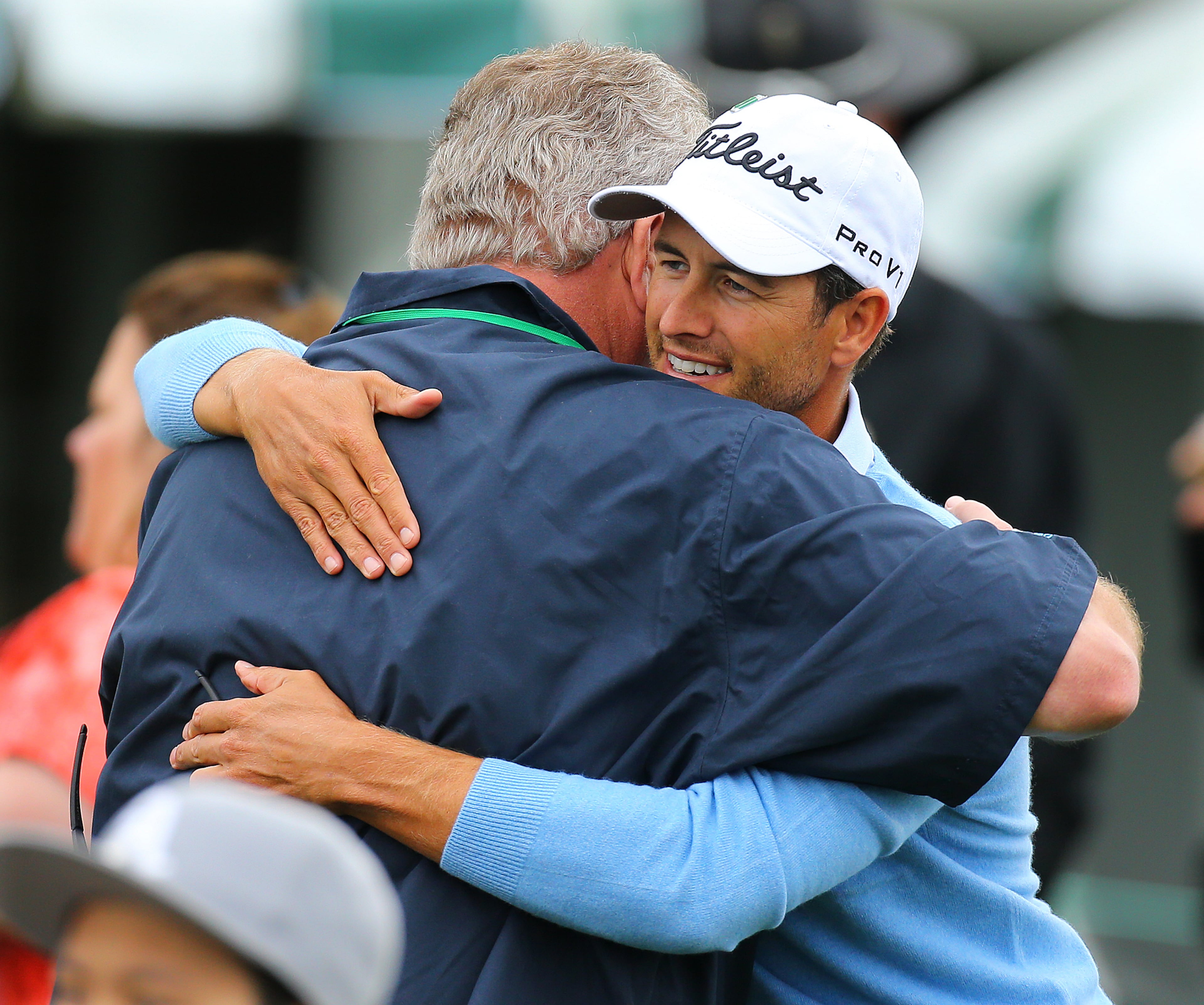 Defending Masters champion Adam Scott, who beat Angel Cabrera in a playoff, gets a hug from a well-wisher on his way to the first tee to begin his practice round at Augusta National Golf Club on Sunday, April 6, 2014, in Augusta. CURTIS COMPTON / CCOMPTON@AJC.COM