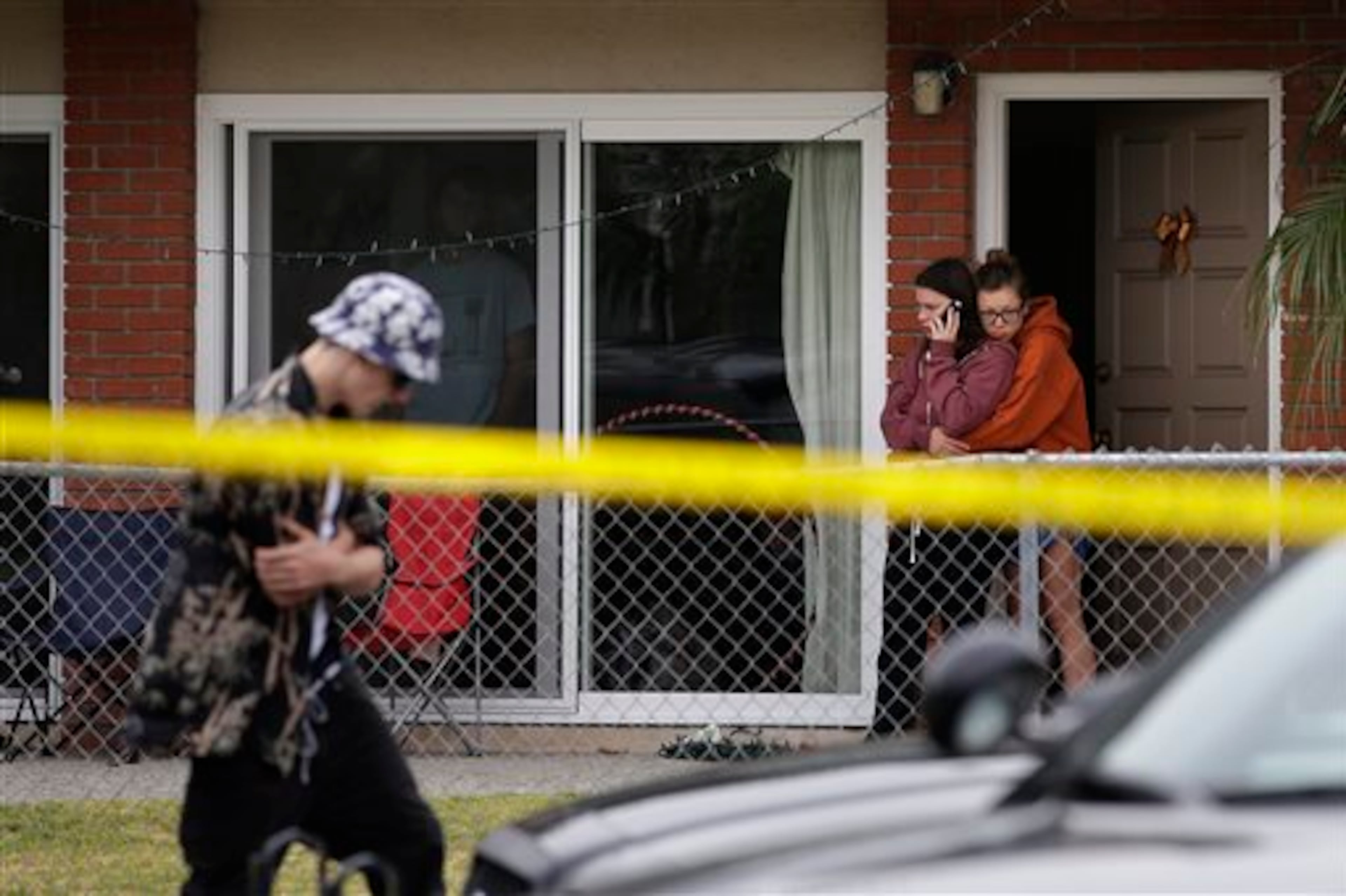 Two women comfort each other near the scene of a shooting on Saturday, May 24, 2014, in Isla Vista, Calif. A drive-by shooter went on a rampage near a Santa Barbara university campus that left seven people dead, including the attacker, and seven others wounded, authorities said Saturday. (AP Photo/Jae C. Hong)