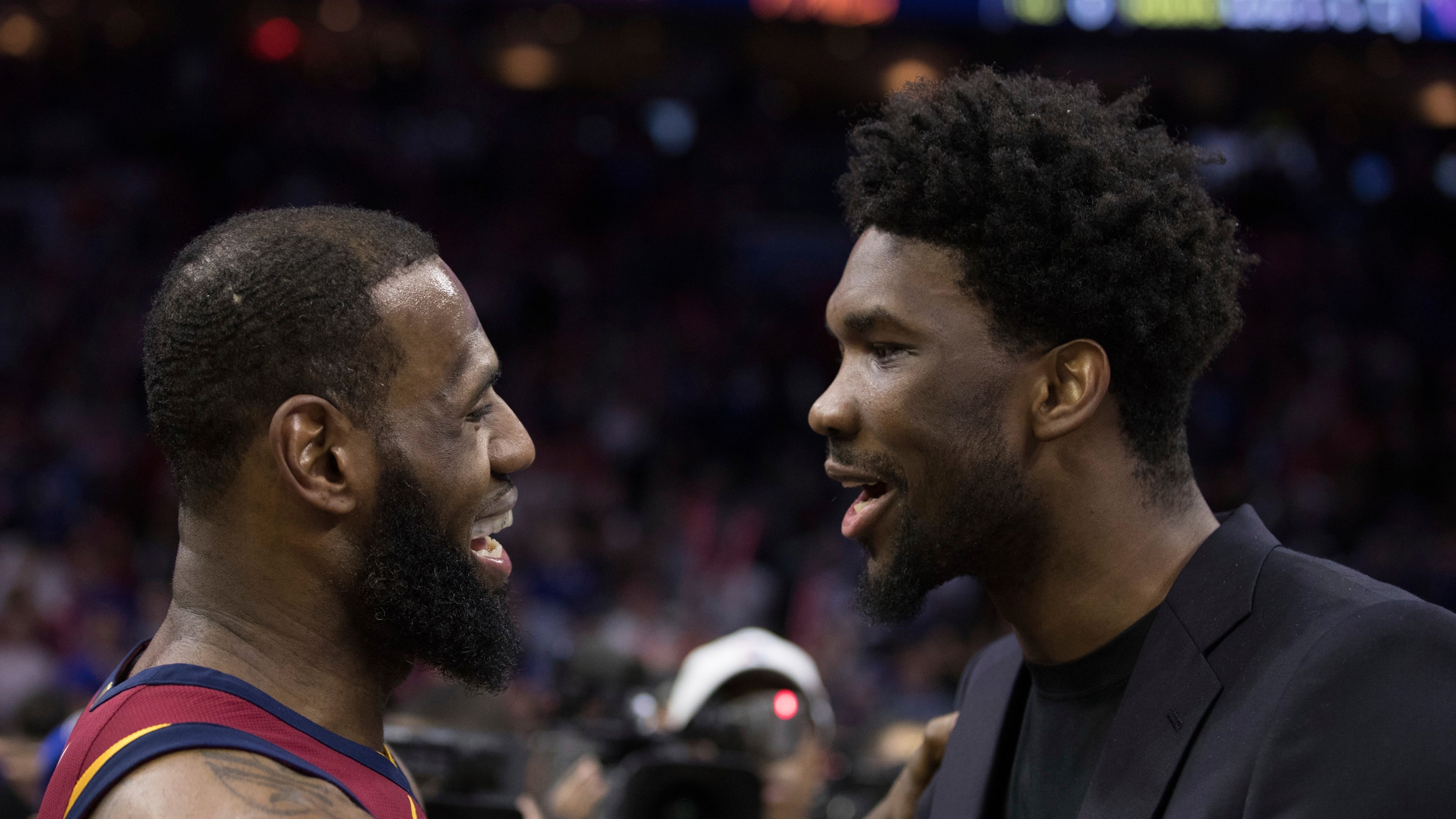 FILE - Cleveland Cavaliers' LeBron James, left, talks with Philadelphia 76ers' Joel Embiid, right, of Cameroon, after the second half of an NBA basketball game, April 6, 2018, in Philadelphia. (AP Photo/Chris Szagola, File)