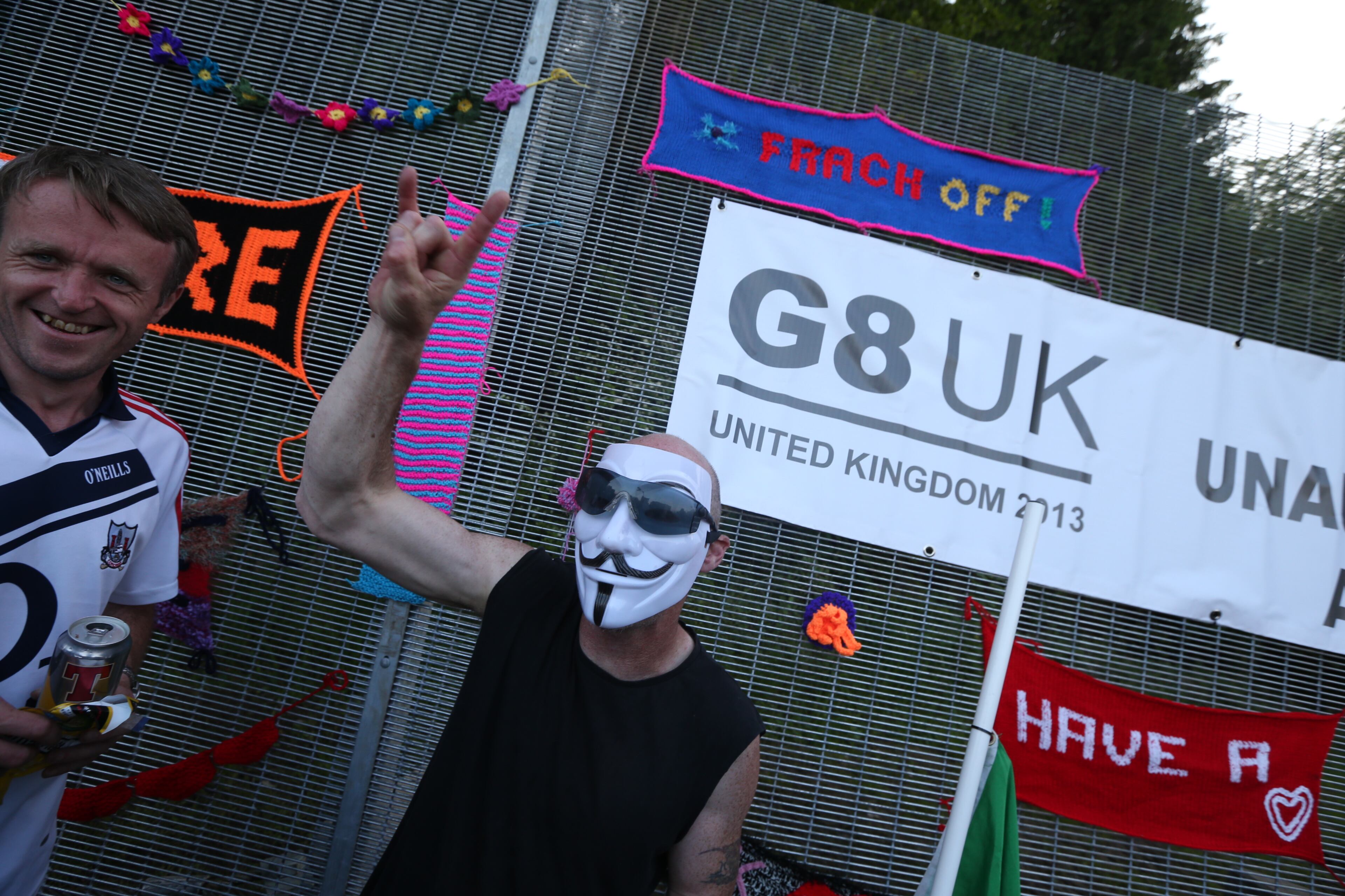 Protesters demonstrate next to the security fence surrounding the G8 Summit venue at Lough Erne on June 17, 2013 in Enniskillen, Northern Ireland. The two day G8 summit, hosted by UK Prime Minister David Cameron, is being held in Northern Ireland for the first time. Leaders from the G8 nations have gathered to discuss numerous topics with the situation in Syria expected to dominate the talks. (Photo by Peter Macdiarmid/Getty Images)