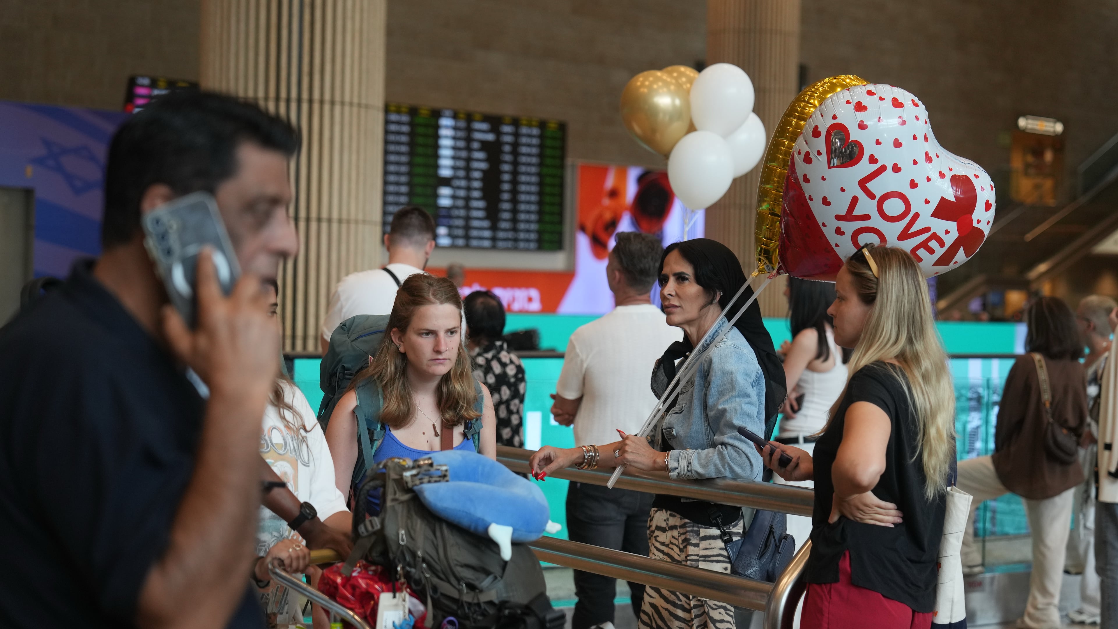 Holding balloons people wait for the arrival of passengers at Ben Gurion International Airport, near Tel Aviv, Israel, Wednesday, Sept. 30, 2026. (AP Photo/Ariel Schalit)