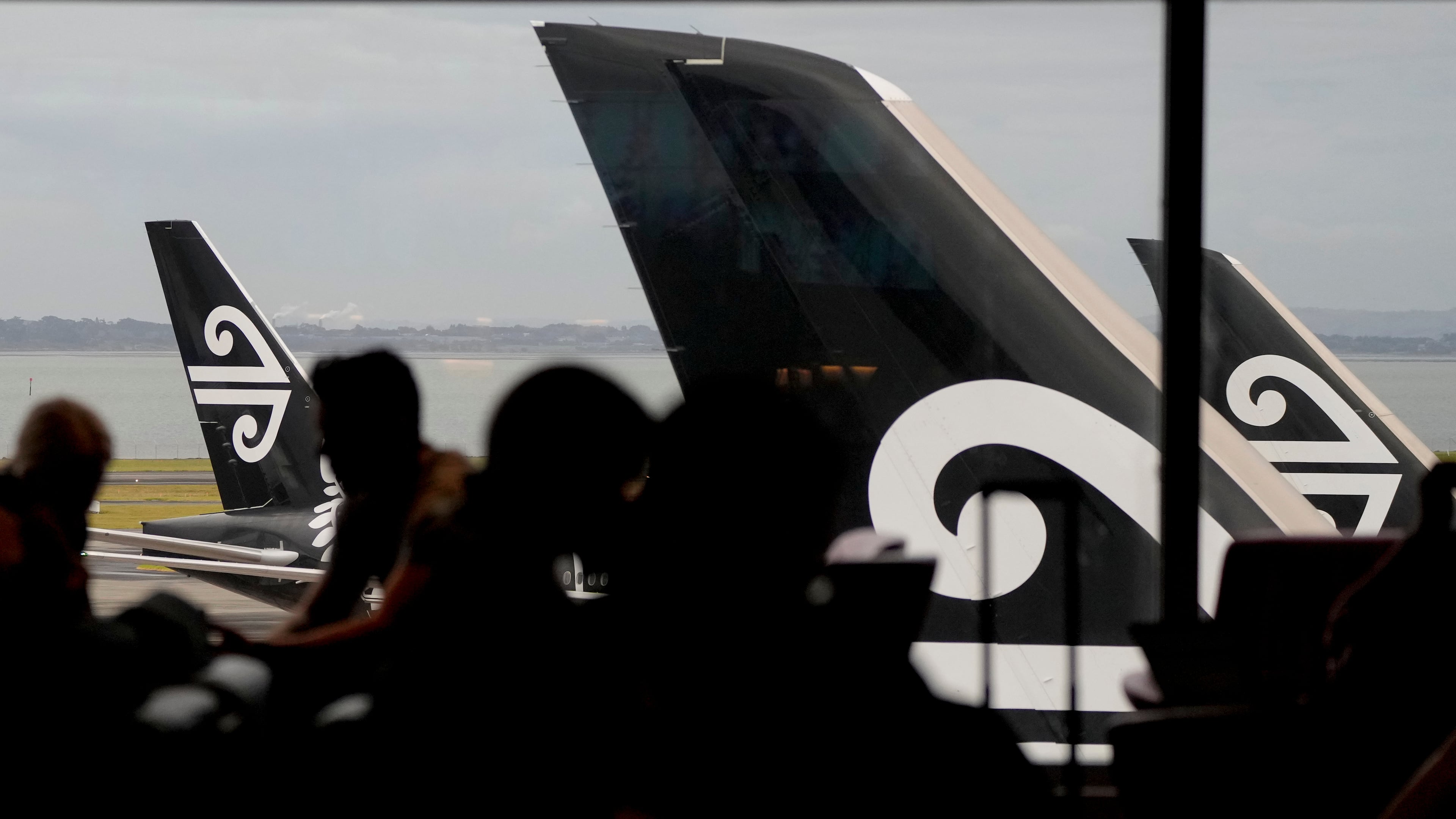 FILE -Passengers wait in the Air New Zealand lounge at Auckland International Airport in Auckland, New Zealand, Wednesday, March 23, 2022.(AP Photo/Mark Baker, File)