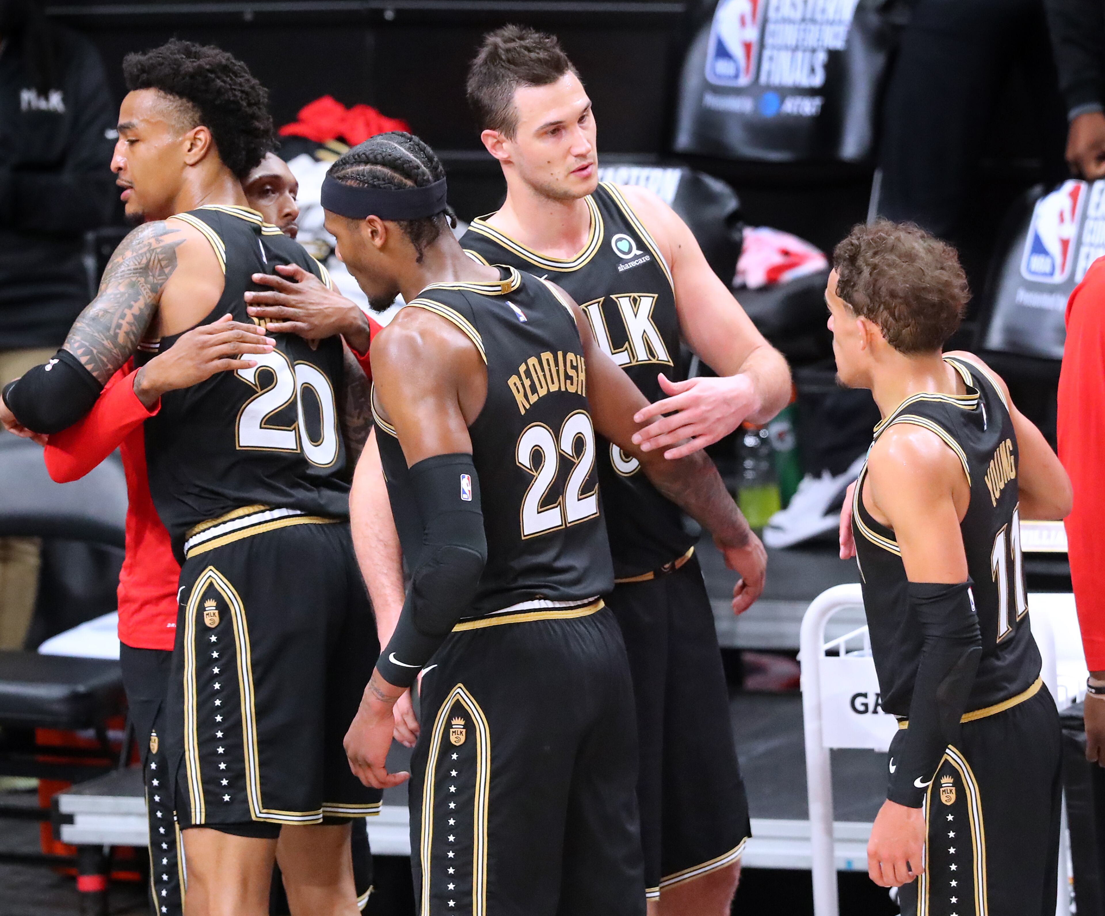 Atlanta Hawks players (from left) John Collins, Lou Williams, Cam Reddish, Danilo Gallinari and Trae Young embrace as they walk off the court after falling to the Milwaukee Bucks in game 6 of the NBA Eastern Conference Finals on Saturday, July 3, 2021, in Atlanta. “Curtis Compton / Curtis.Compton@ajc.com”
