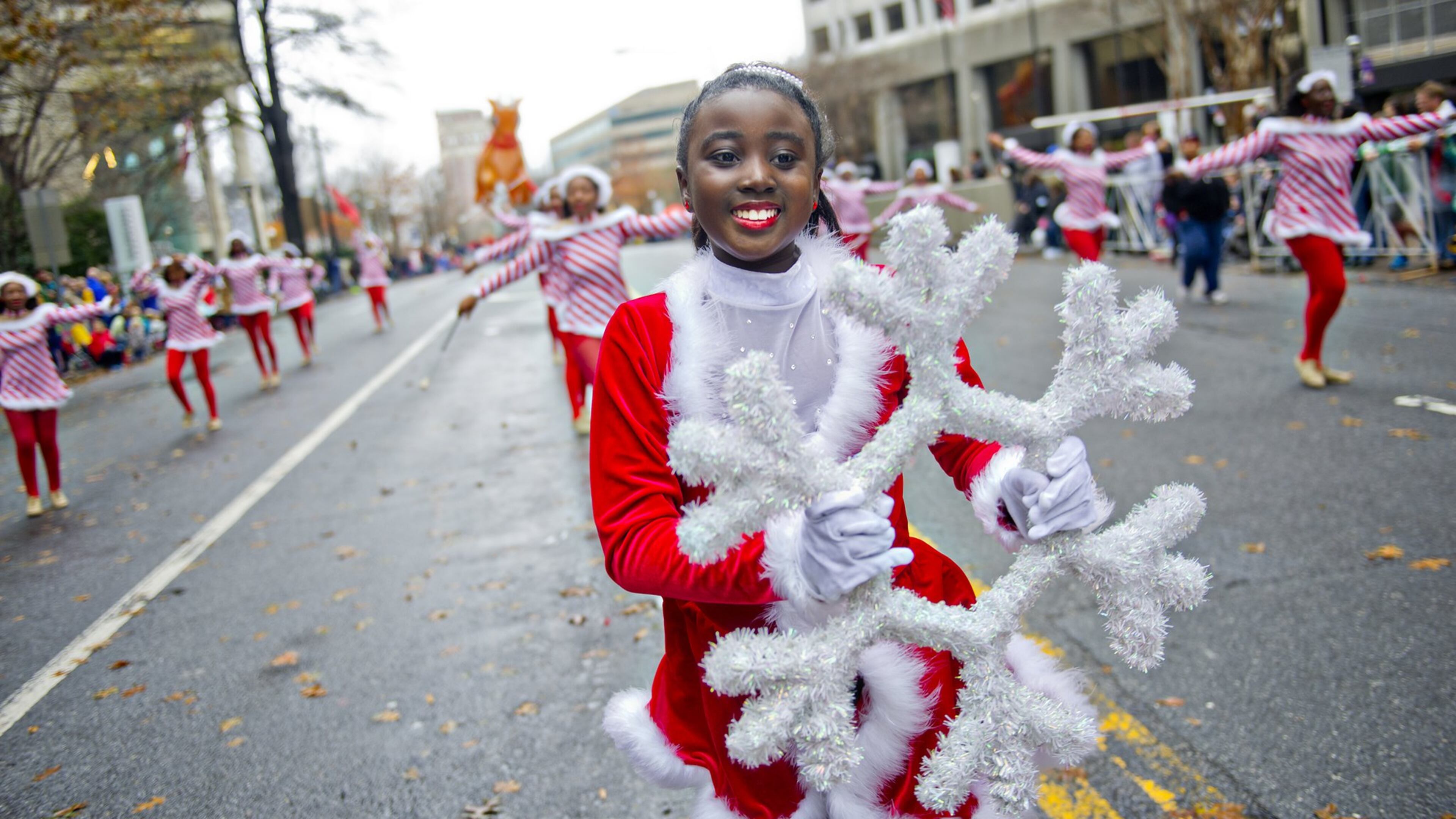 Melvea Safo (center) danced down Peachtree Street in Atlanta during the 2014 Children’s Christmas Parade. This year’s event is Dec. 5. JONATHAN PHILLIPS / SPECIAL
