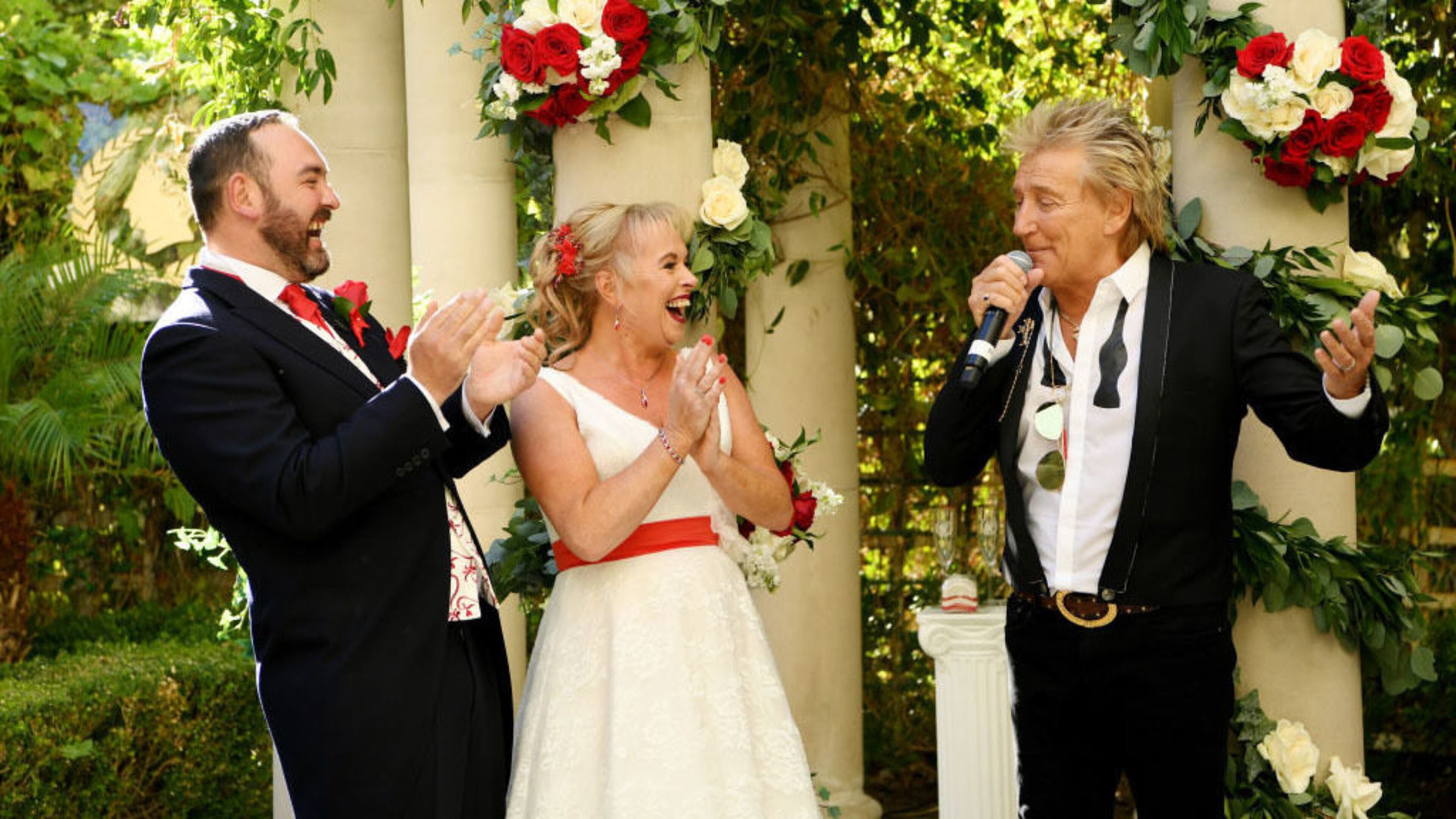 Sir Rod Stewart (R) sings at the wedding of Sharon Cook (C) and Andrew Aitchison (L) from Liverpool, England. The wedding was nearly canceled due to the Thomas Cook bankruptcy debacle, but Caesars Palace stepped in and made arrangements.