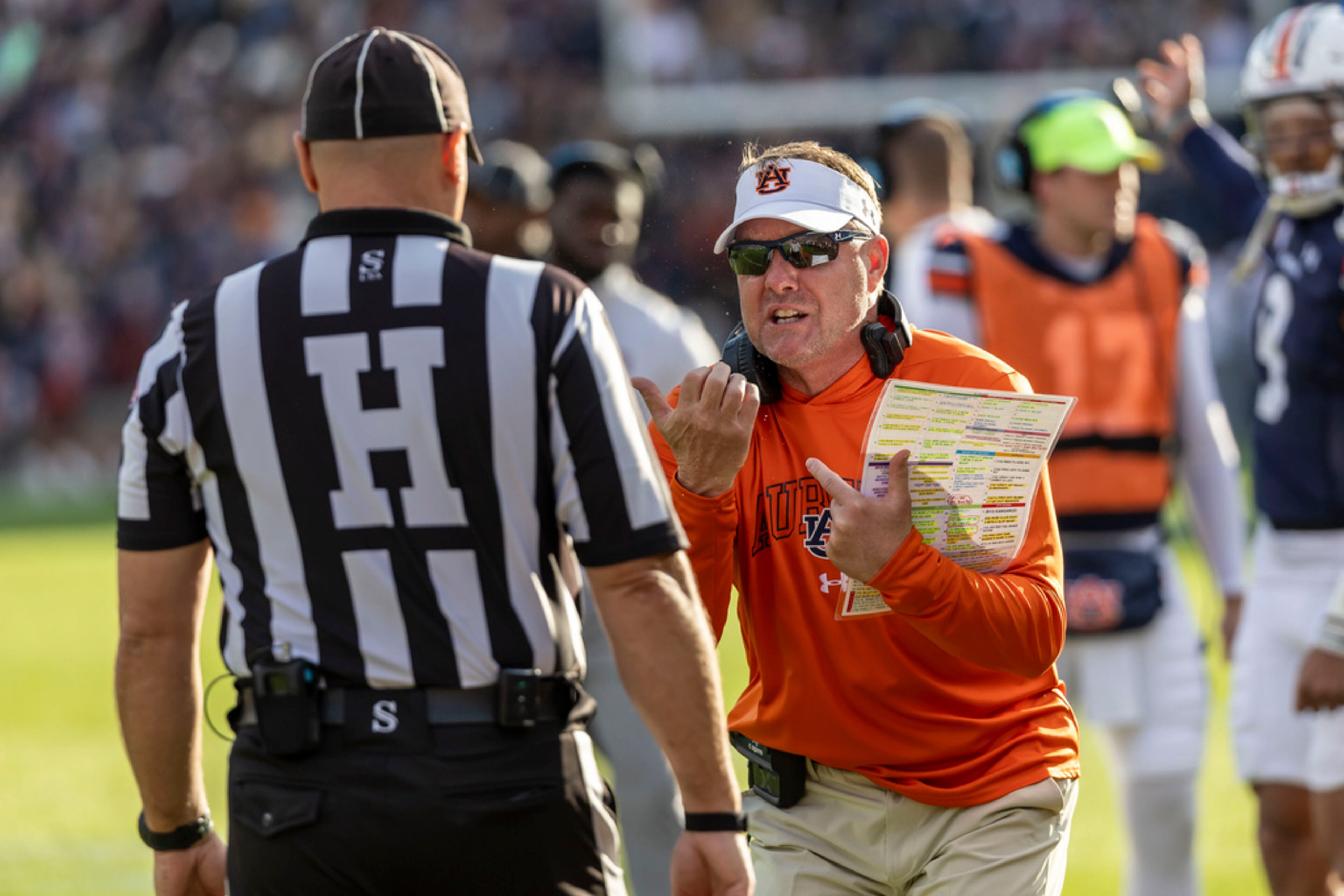 Auburn head coach Hugh Freeze, right, argues a missed call during the first half of an NCAA college football game against Alabama, Saturday, Nov. 25, 2023, in Auburn, Ala. (AP Photo/Vasha Hunt)