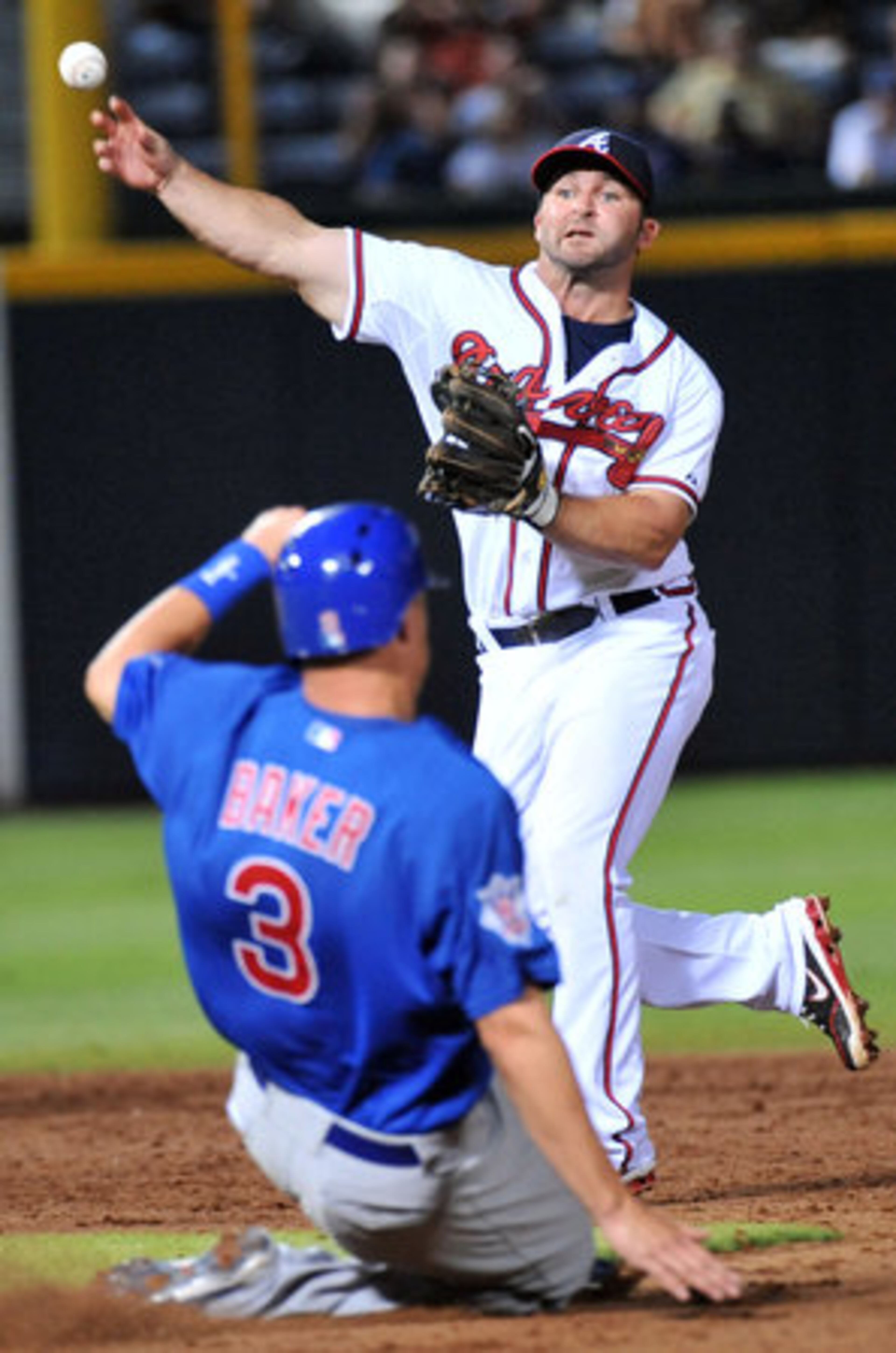 Atlanta Braves Dan Uggla (26) throws to first base after forcing out Chicago Cubs Jeff Baker (3) on the double play in the 8th inning of the final game of four-game series at Turner Field in Atlanta on Thursday, July 5, 2012.