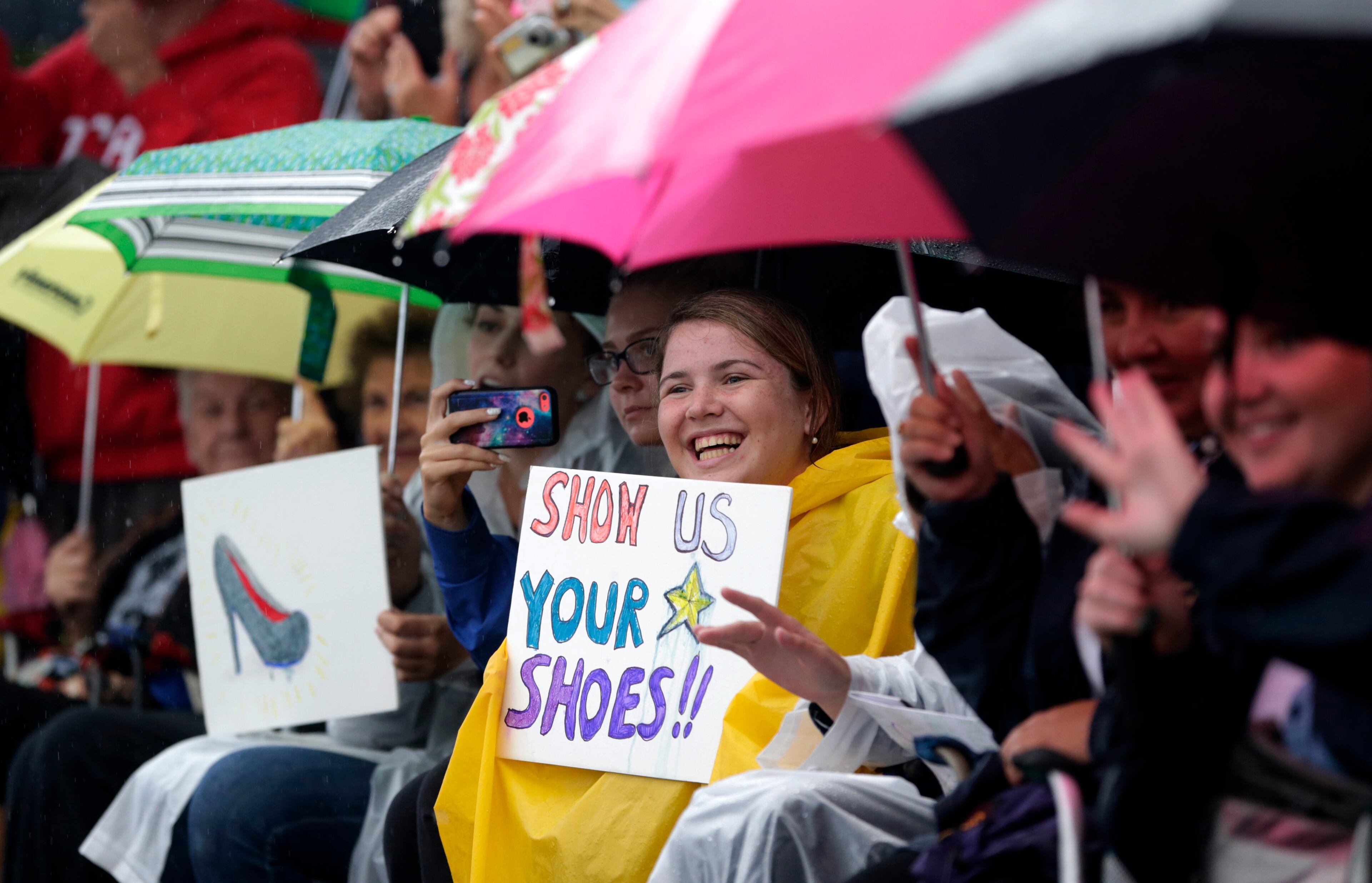 A spectator holds up a sign during the Miss America Shoe Parade at the Atlantic City boardwalk, Saturday, Sept. 13, 2014, in Atlantic City, N.J. (AP Photo/Julio Cortez)
