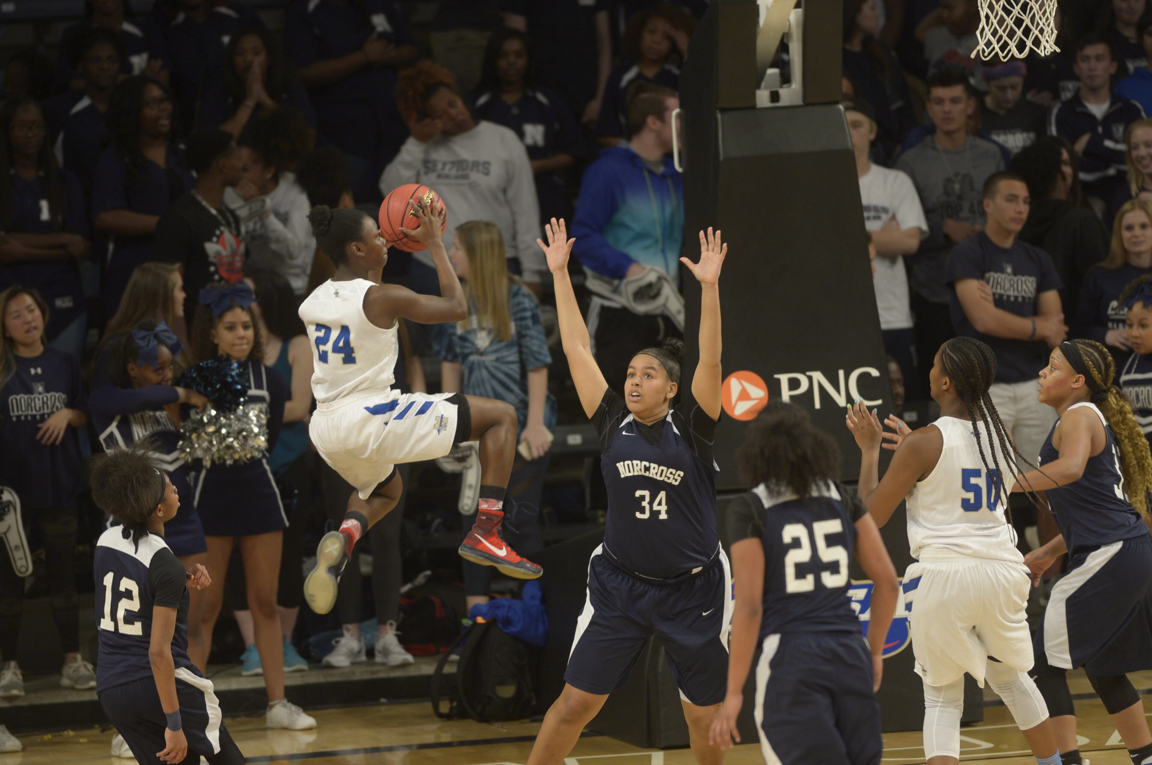 Atlanta, Ga. -- McEachern junior Victoria Agyin (24) attempts a jump shot over Norcross junior Devyn Wilson (34) in the first half of their Class AAAAAAA state championship game at Georgia Tech's McCamish Pavillion Friday, March 10, 2017. SPECIAL/Daniel Varnado