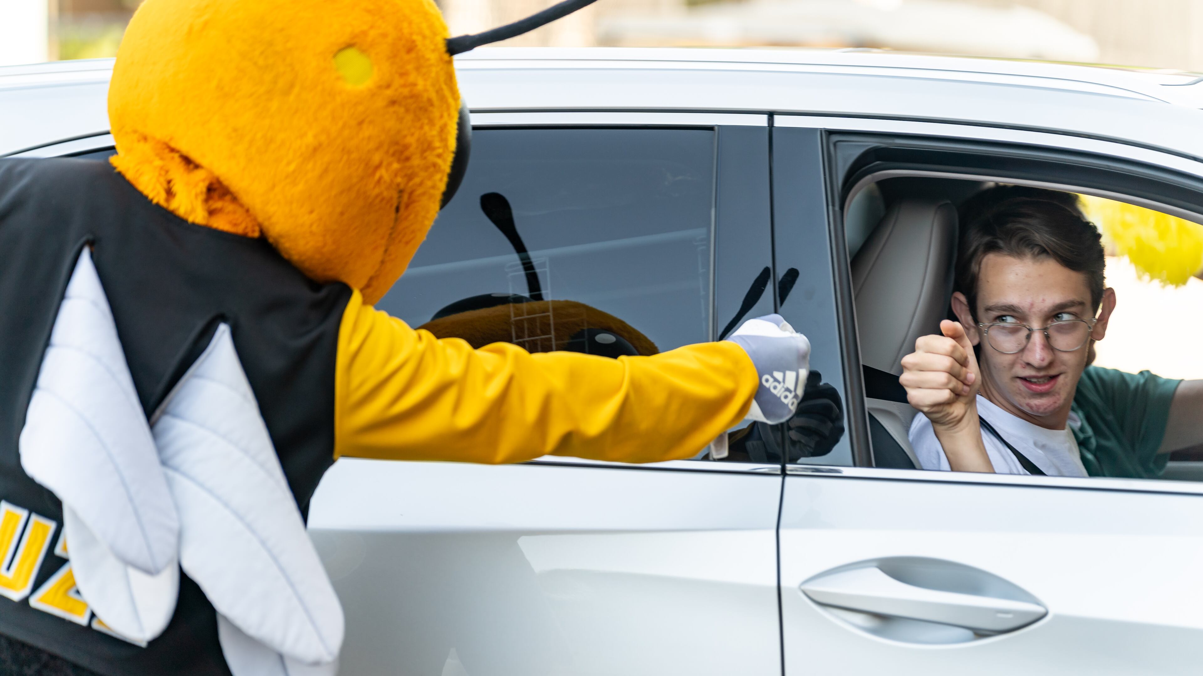 Jack Rumpf, an incoming first-year from Athens, fist-bumps Buzz, Georgia Tech’s mascot, while entering the Campus Recreation Center Parking Deck to check in for move-in on Georgia Tech's campus in Atlanta on Saturday, August 10, 2024. (Seeger Gray / AJC)