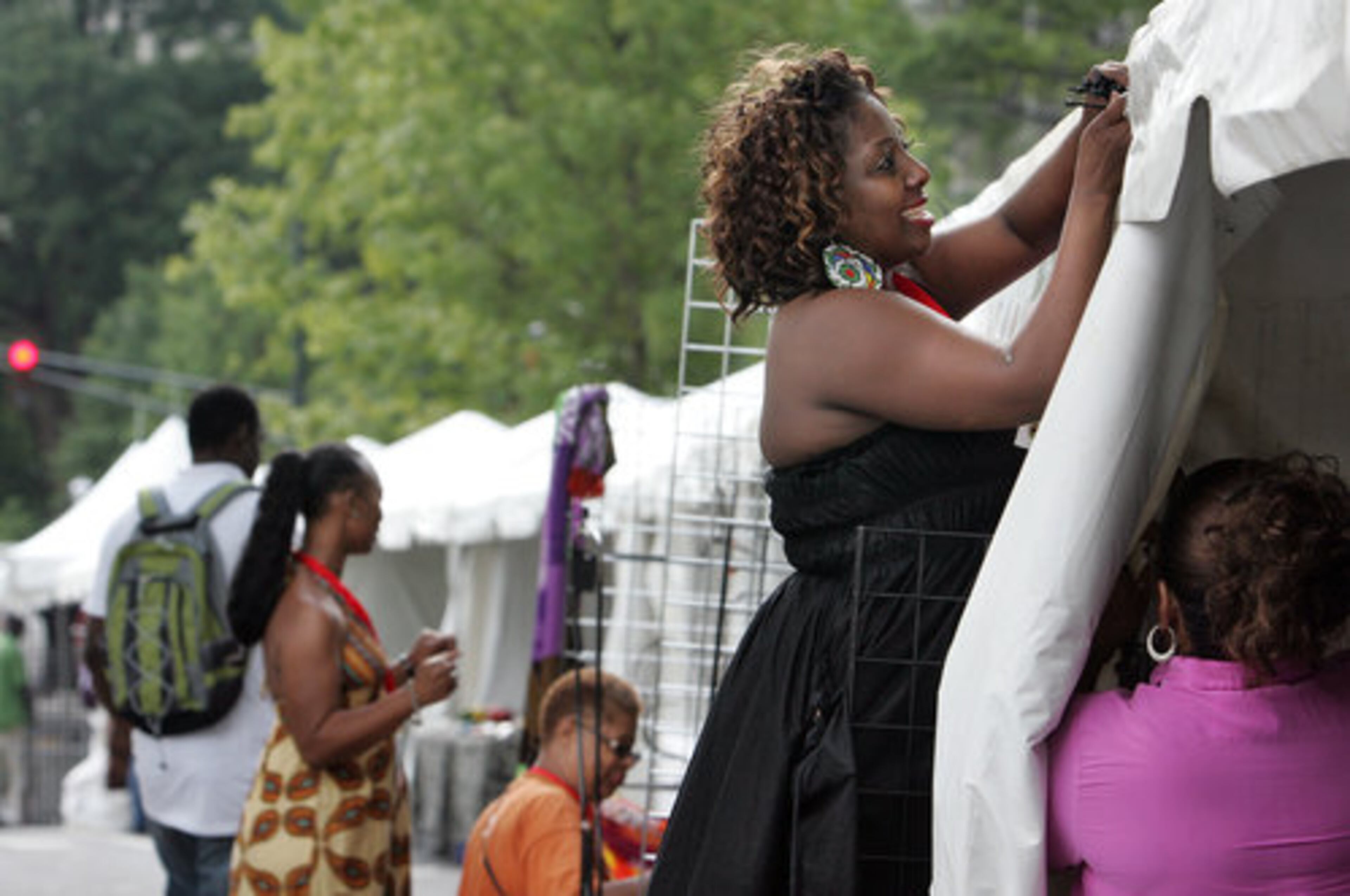 Joy Jackson helps set up "The Hair Cafe" booth at the Marketplace.