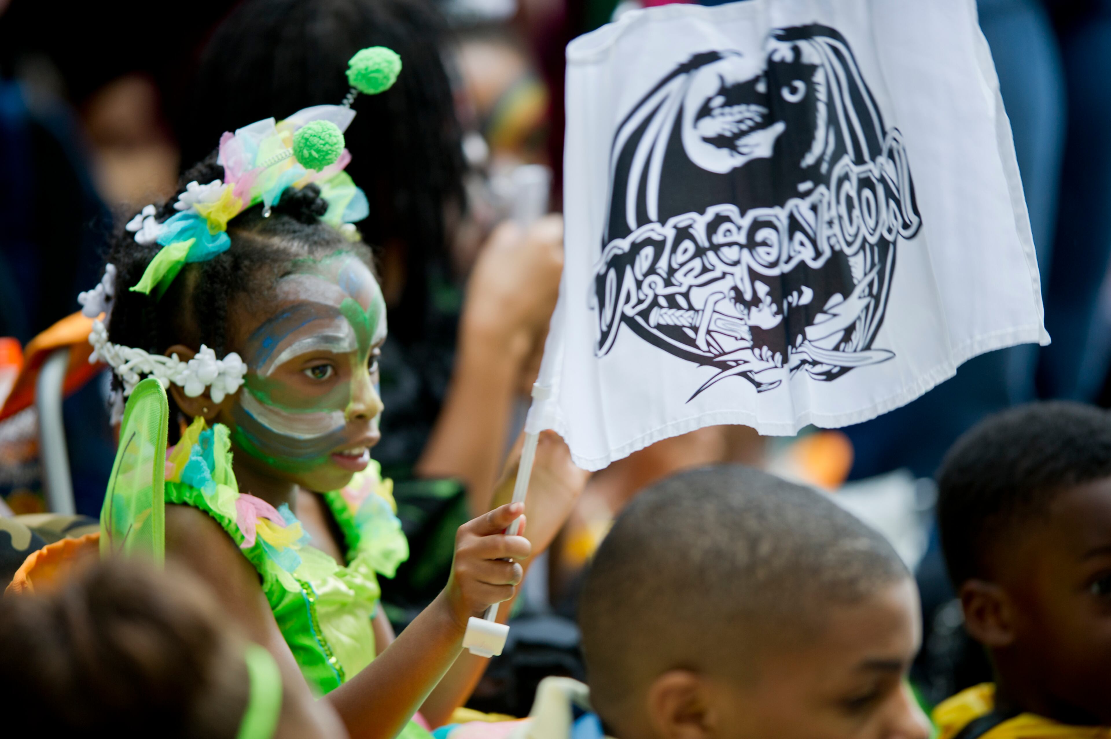De'Andra Roberts waves a DragonCon flag as she watches the annual parade pass through downtown Atlanta on Saturday, August 31, 2013. This year 57,000 people were expected to attend the five day long event which is in its 27th year. JONATHAN PHILLIPS / SPECIAL