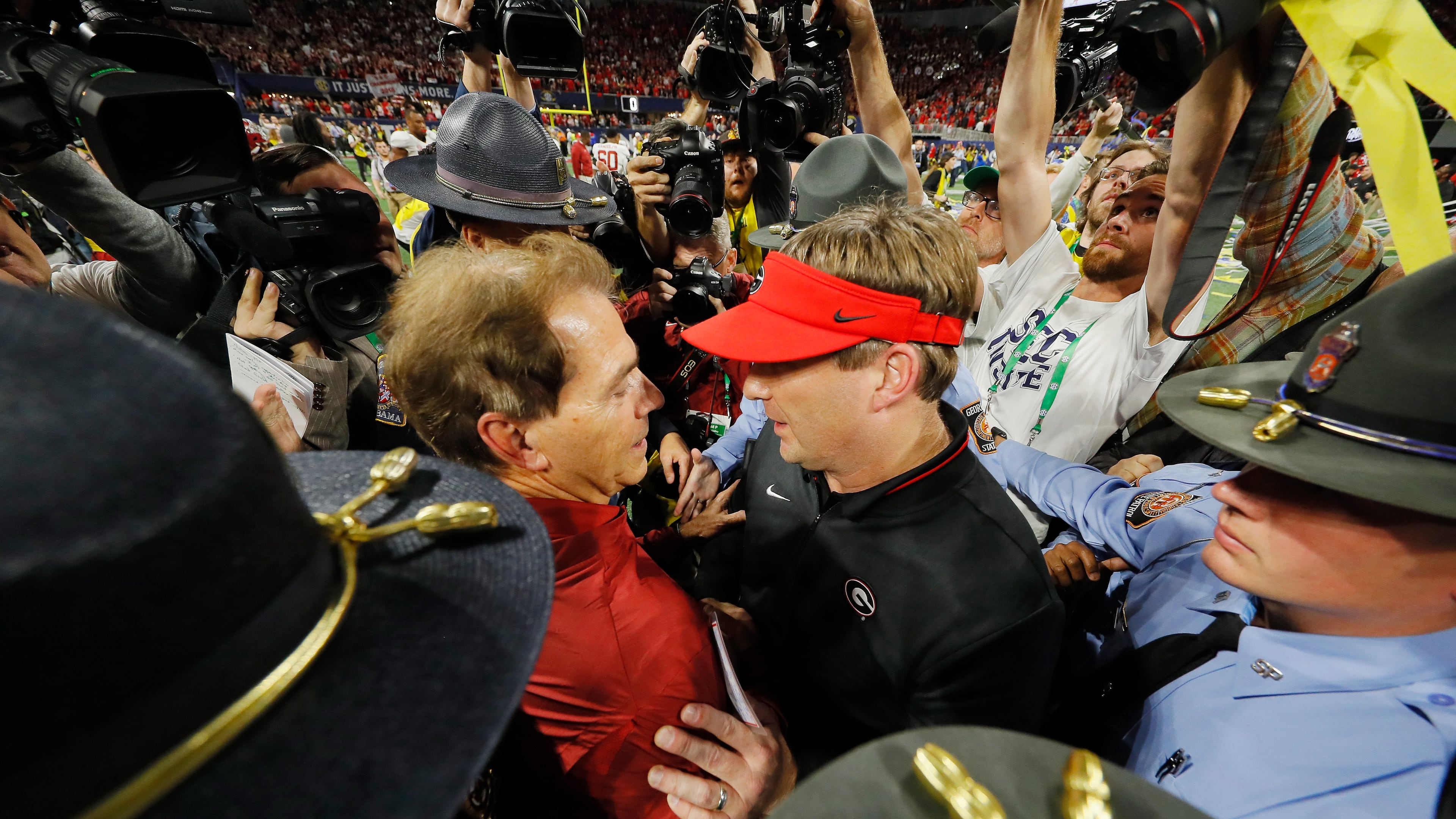 As Alabama begins another celebration inside Mercedes-Benz Stadium, Crimson Tide coach Nick Saban (left) gives his best to Georgia's Kirby Smart.