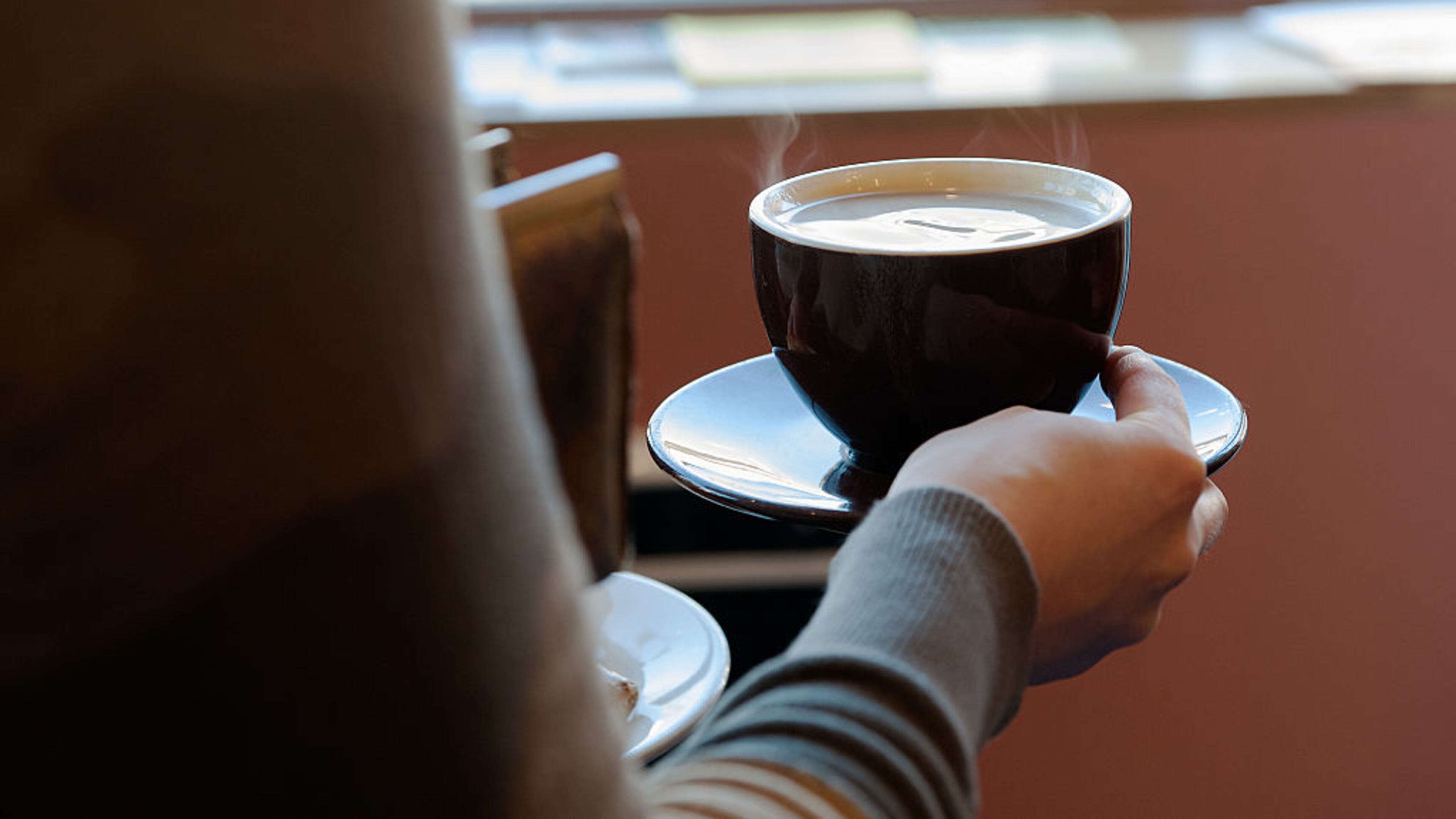 BROOKLYN, NY - FEBRUARY 22: A customer carries a cup of coffee to her table at Colson Patisserie on February 22, 2016 in the Brooklyn borough of New York City. A recently released study found that drinking two cups of coffee a day decreases one's chance of developing liver cirrhosis by 44 percent.
(Photo by Bryan Thomas/Getty Images)