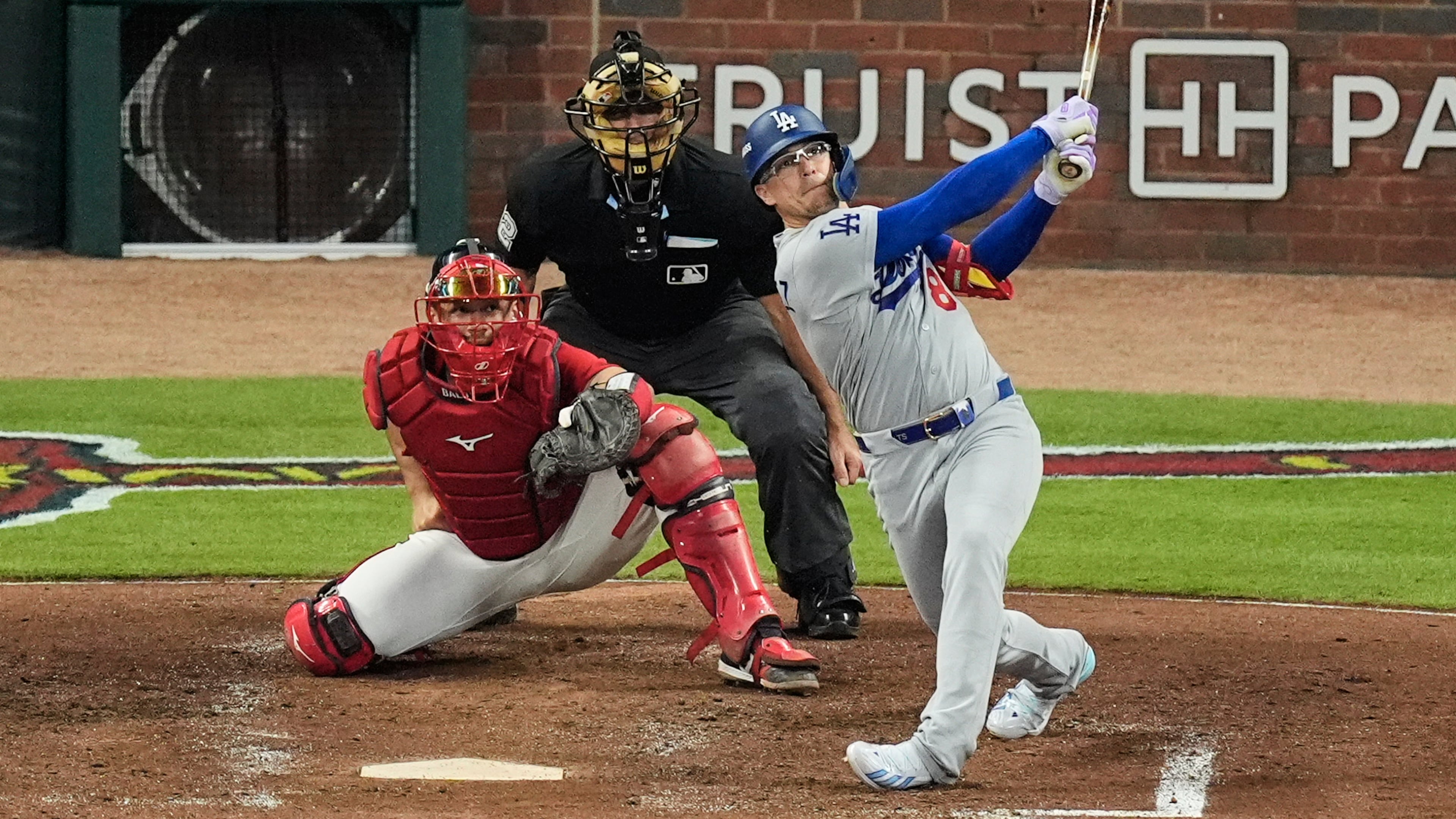 Los Angeles Dodgers' Enrique Hernández follows through on a two-run home run as Atlanta Braves catcher Drake Baldwin (30) and umpire James Hoye look on during the fourth inning in Game 3 of baseball's National League Division Series, Tuesday, Oct. 6, 2026, in Atlanta. (AP Photo/Mike Stewart)
