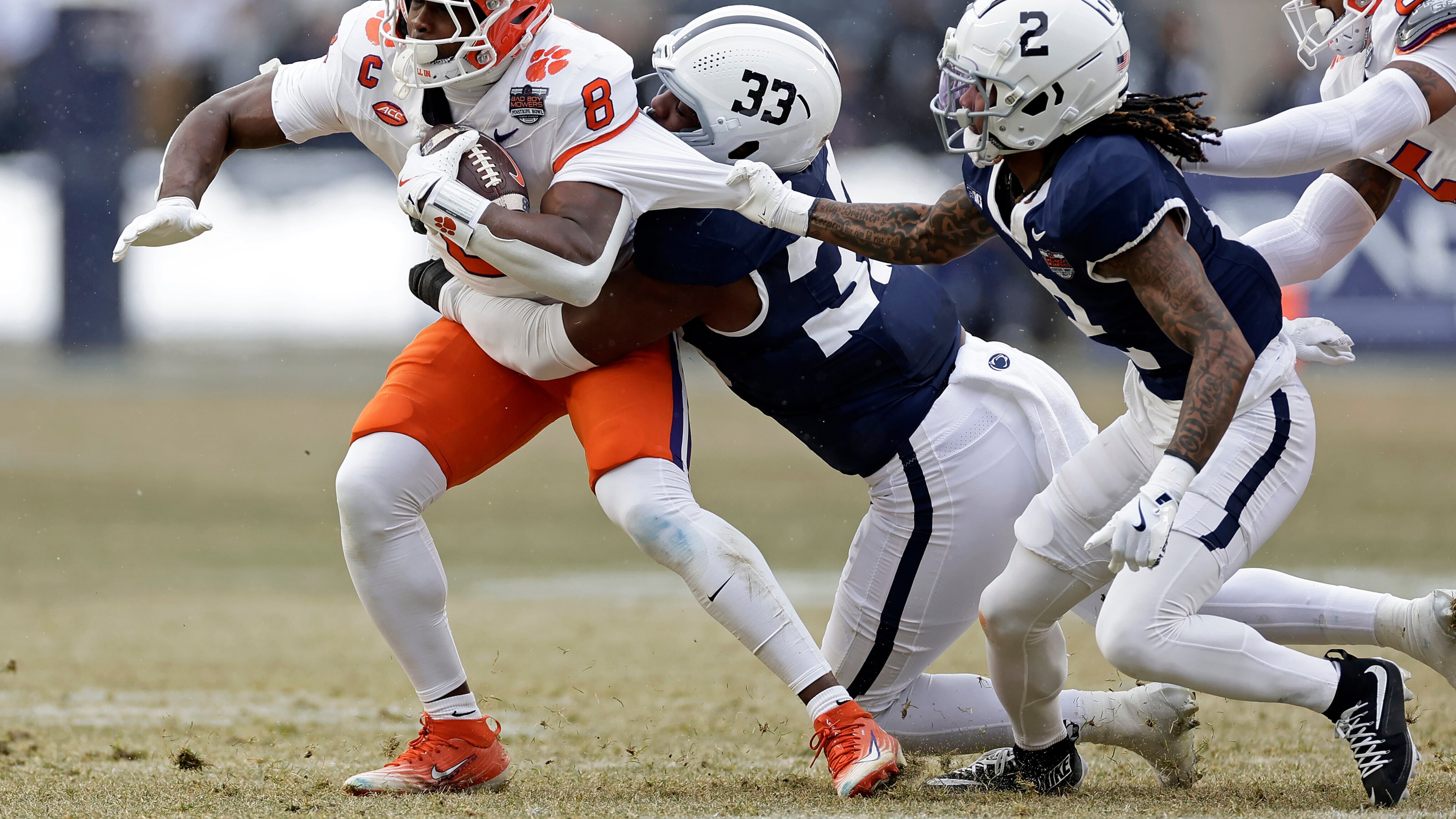 Clemson running back Adam Randall is tackled by Penn State cornerback Audavion Collins and defensive end Dani Dennis-Sutton during the first half of the Pinstripe Bowl at Yankee Stadium in December. (Adam Hunger/AP 2025)