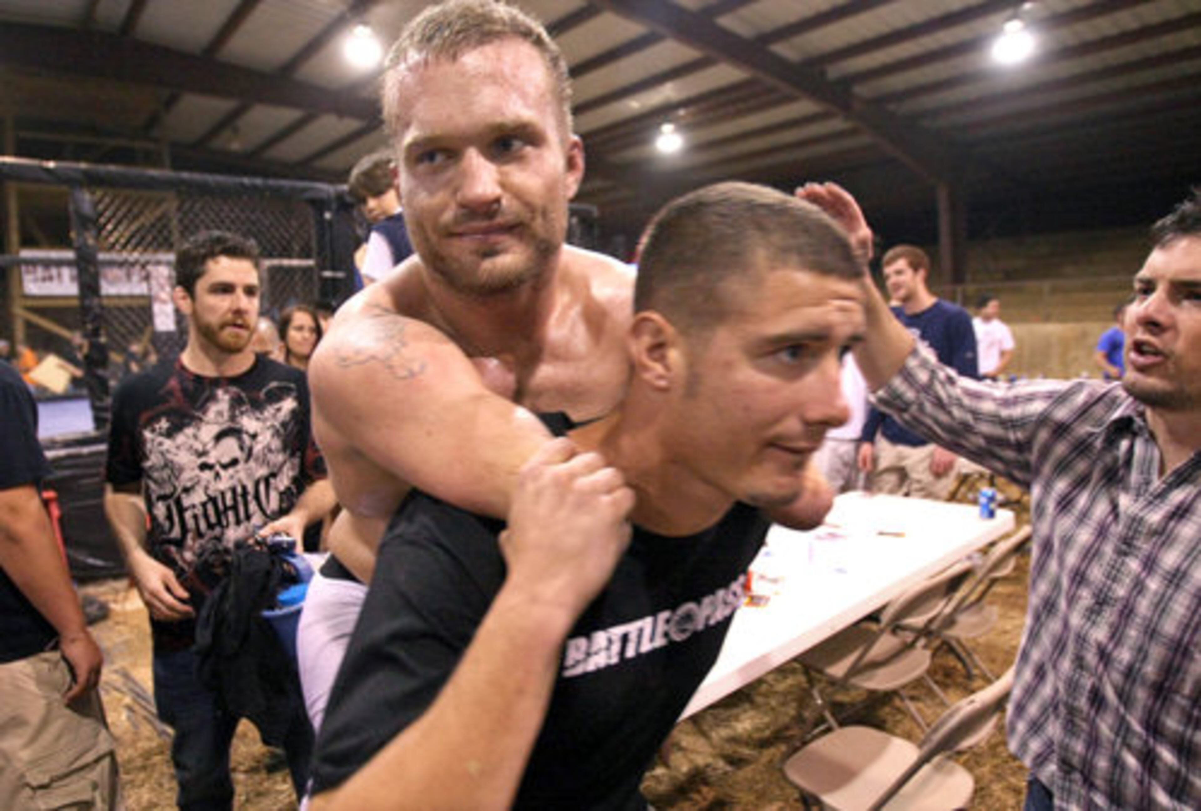 Maynard gets a lift from friend and trainer Davis as he leaves the ring after his loss.