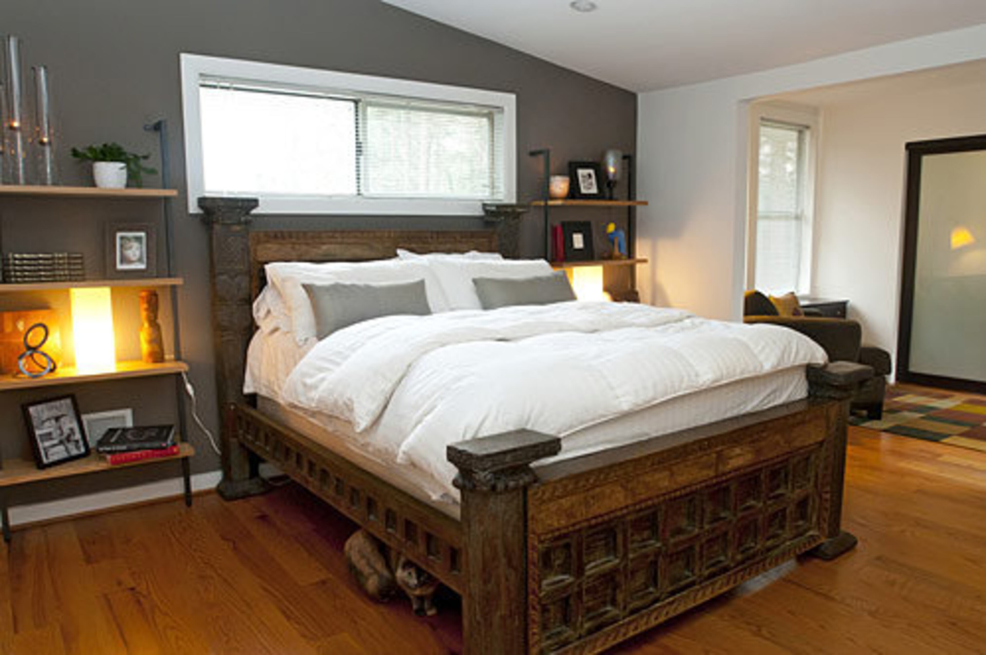 The master bedroom features a reclaimed Indian wood bed and a naturally lit walk-in closet that was once a sunroom.