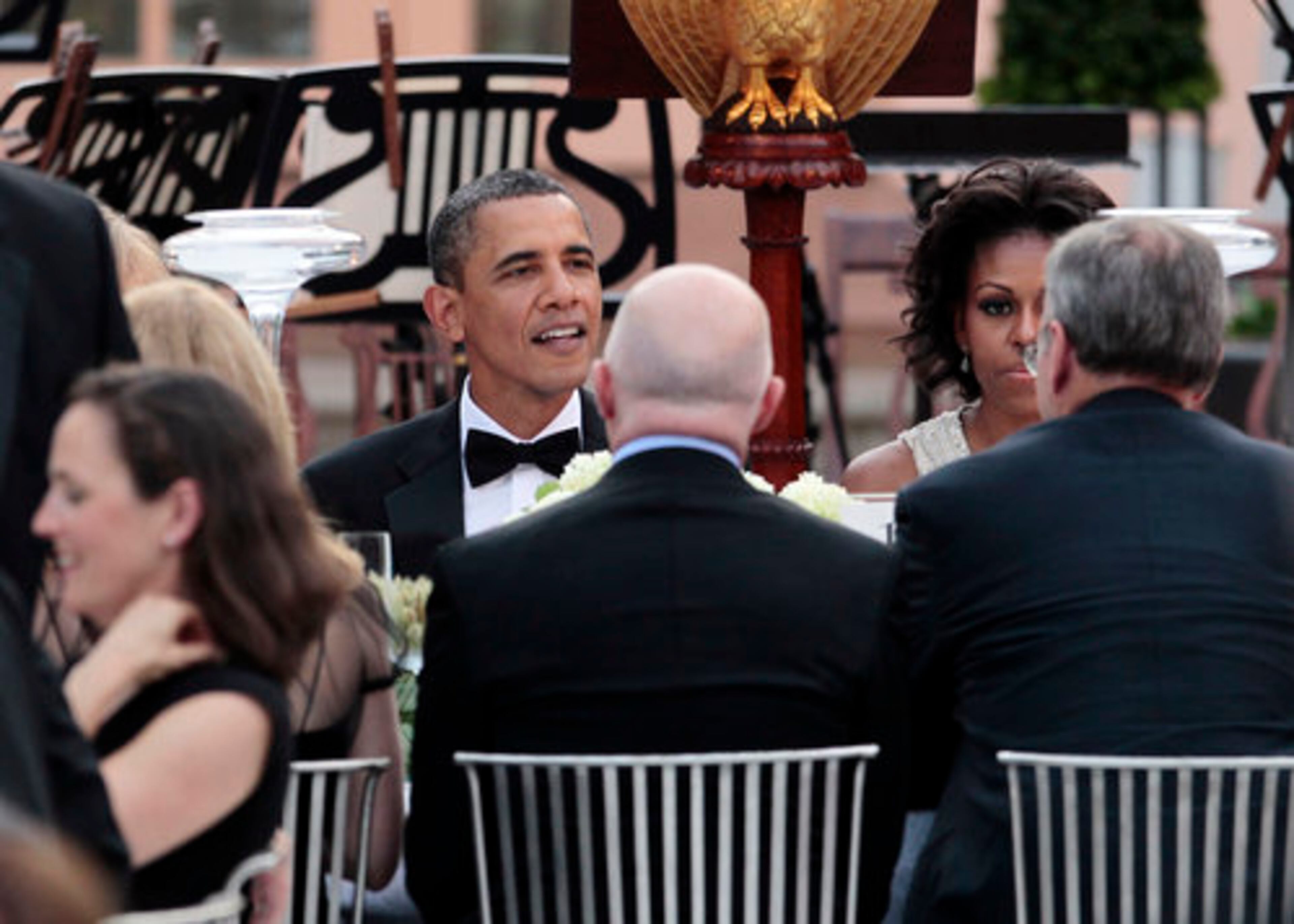 President Barack Obama and first lady Michelle Obama talk with guests.