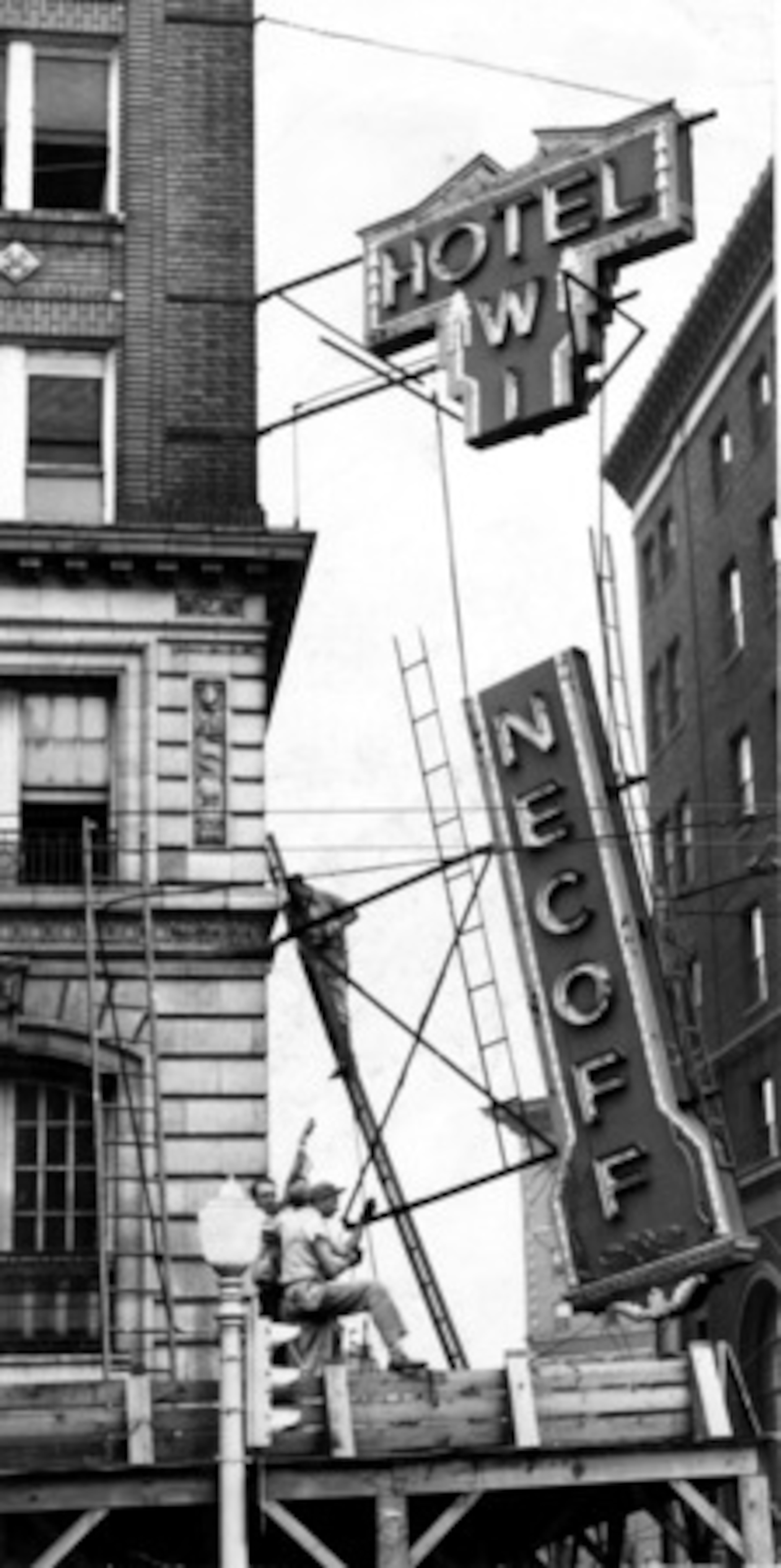 In June 1947, workmen remove the Winecoff sign after a court order. The receiver for the hotel filed a petition in court asking that the sign be dismantled. He contended it served no purpose other than to act as a reminder of the tragedy, which claimed 119 lives.