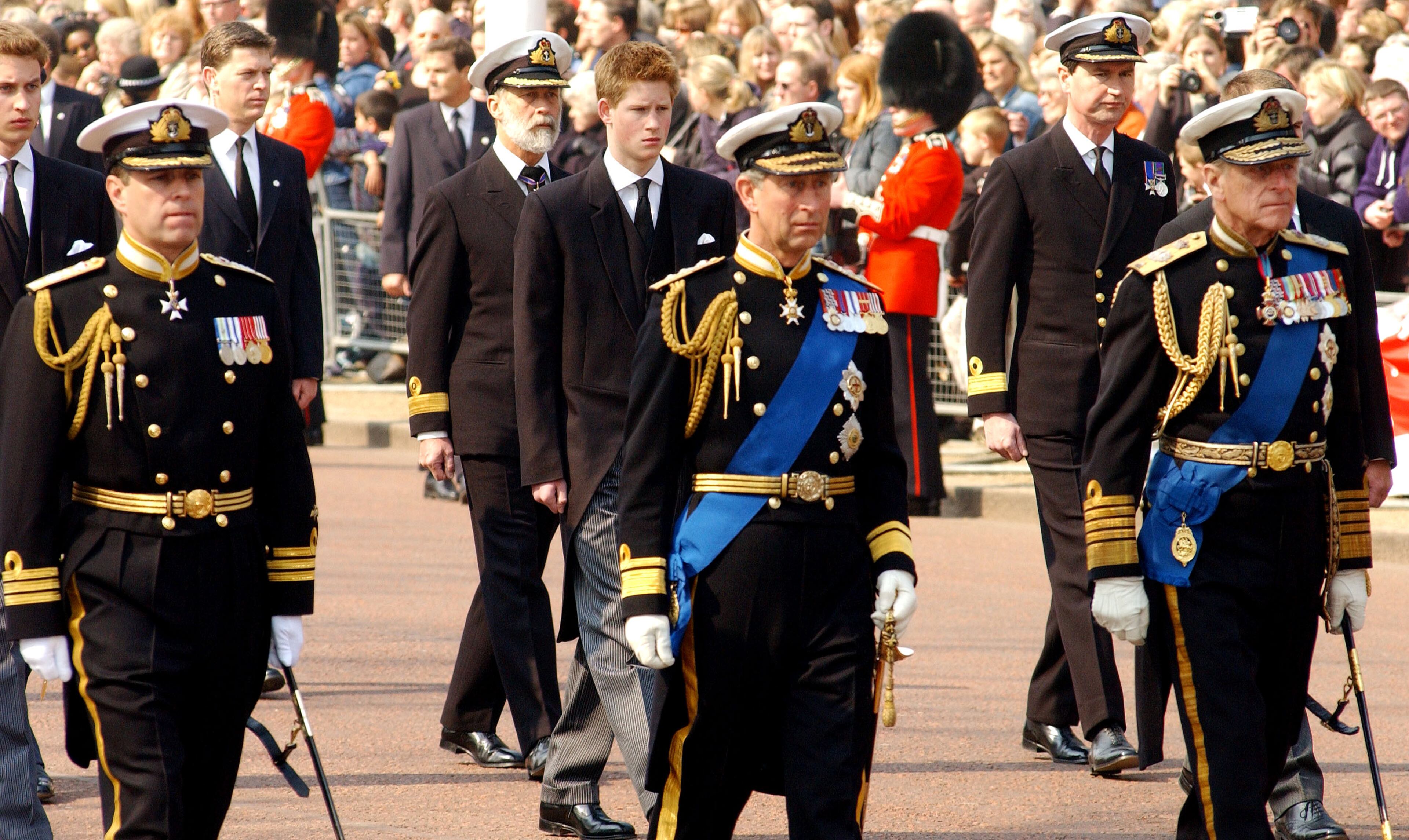 Britain's Prince Charles (right), Prince Phillip (center) and Prince Andrew (left) lead Prince Harry and other Royals as they walk behind the coffin bearing the Queen Mother on April 5, 2002, as her ceremonial procession makes its way down the Mall in London.