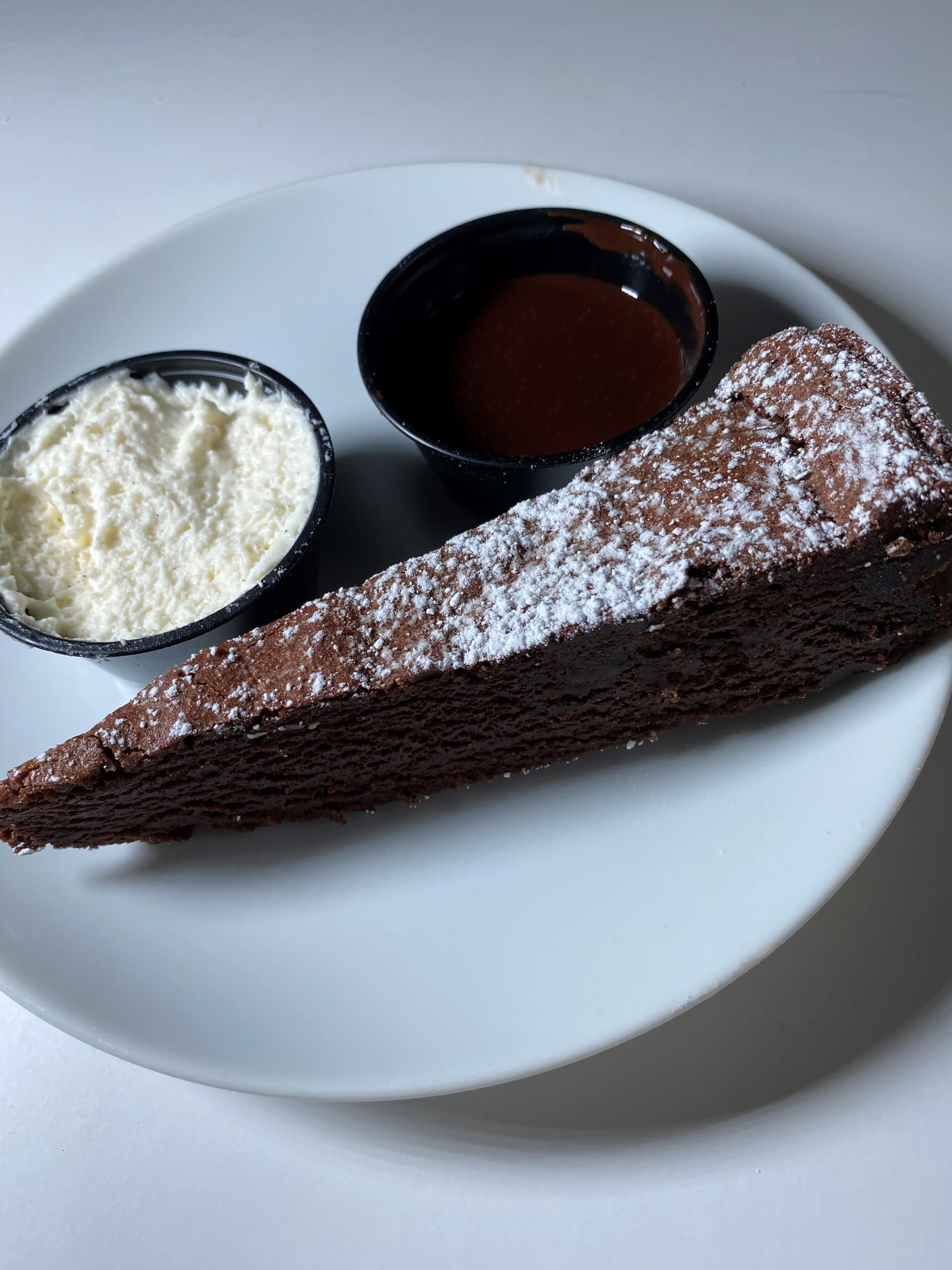 For dessert at Kaiser’s Chophouse, you can try flourless chocolate cake, with whipped cream and chocolate sauce. Bob Townsend for The Atlanta Journal-Constitution