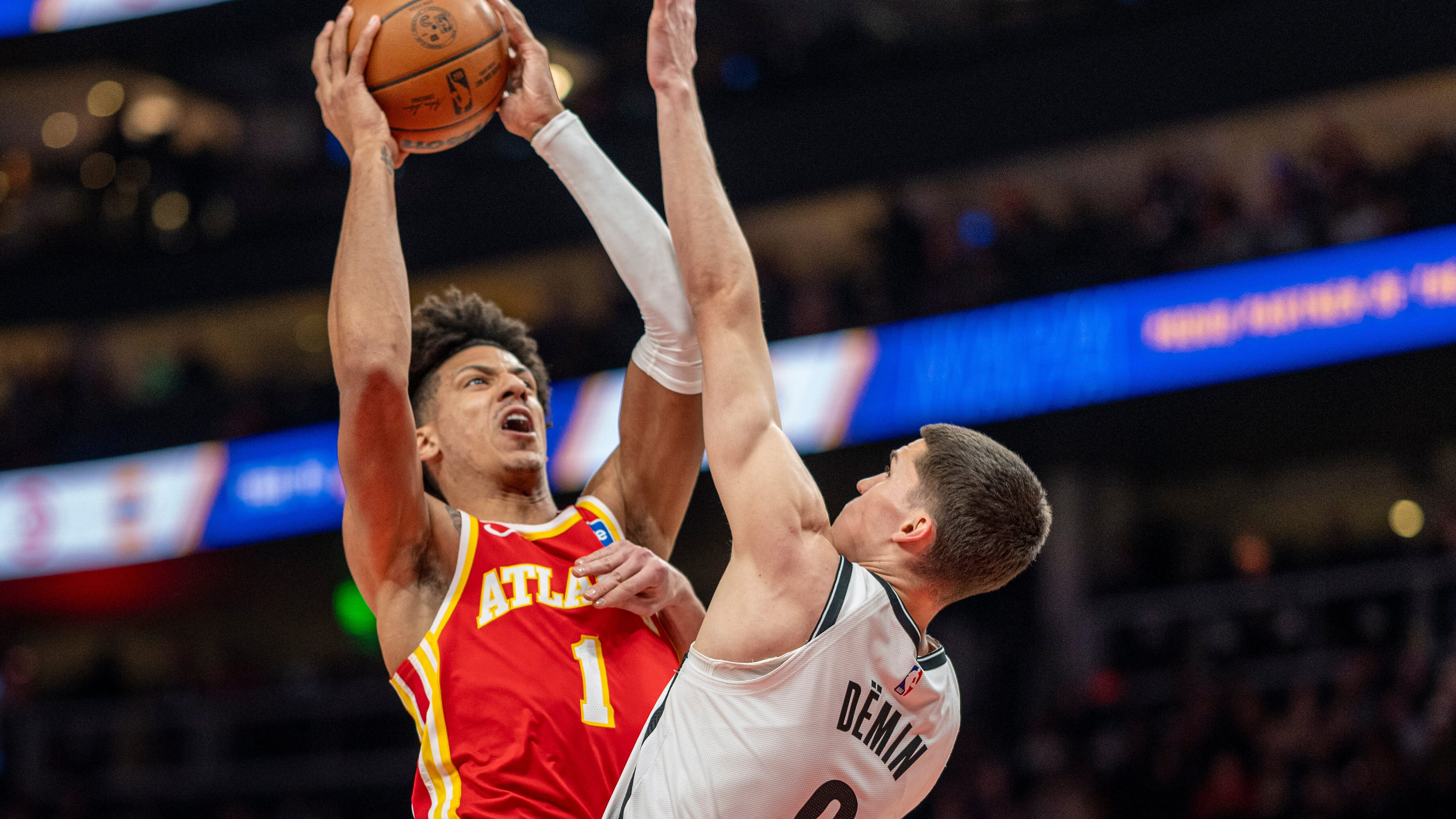 Atlanta Hawks forward Jalen Johnson attempts a basket over Brooklyn Nets guard Egor Dëmin during the first half of Sunday's game. (Erik Rank/AP)