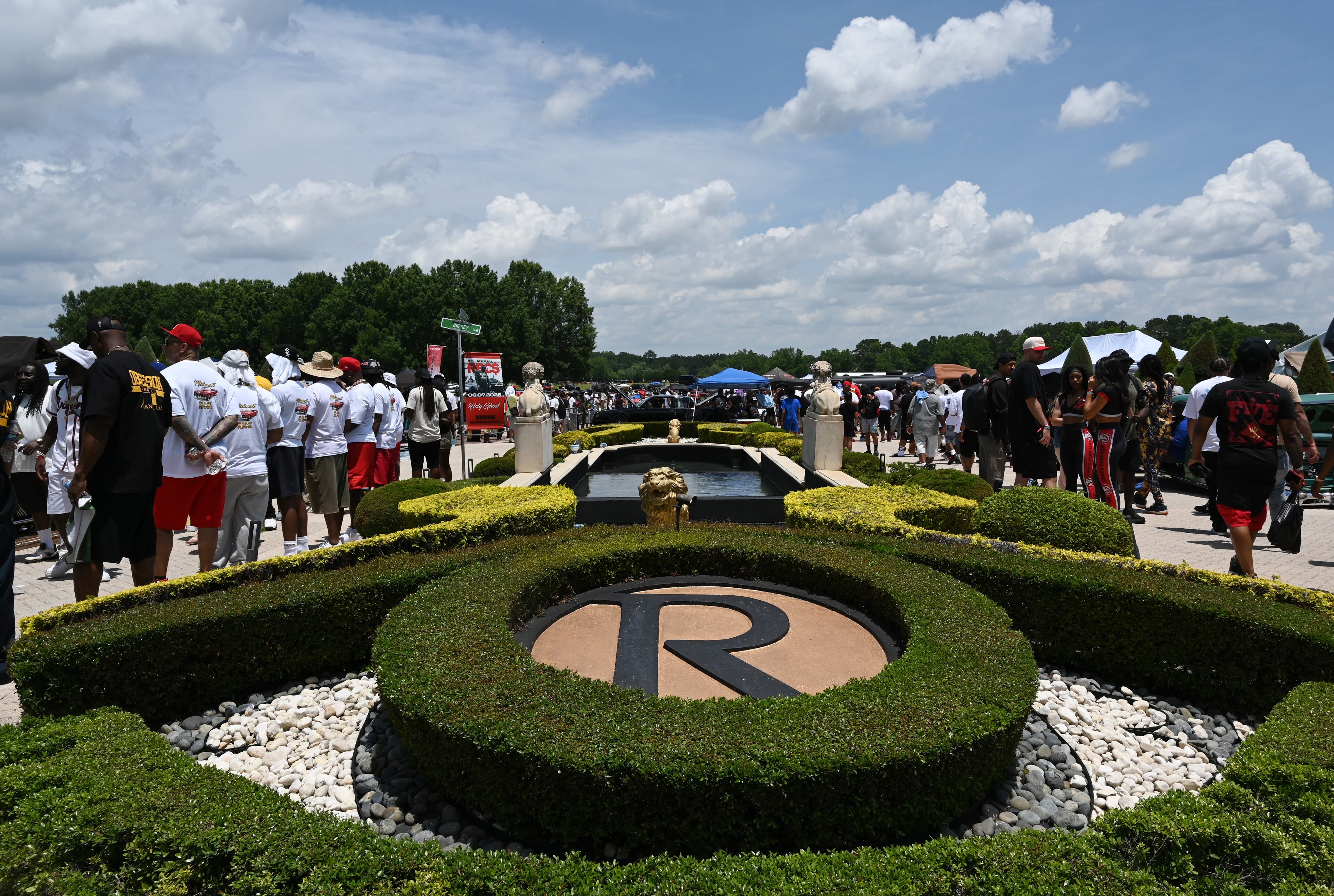 Attendees walk through fleets of classic/custom automobiles, luxury vehicles, boats, RVs and trailers on the front of the mansion during the 4th Annual Rick Ross Car and Bike Show, Saturday, June 7, 2025, in Fayetteville. The 4th Annual Rick Ross Car and Bike Show will include a vendor market with more than 30 vendors, food trucks, fleets of classic/custom automobiles, luxury vehicles, boats, RVs and trailers on the front of the mansion. Stage performances include Plies, Ross' new signee Nino Breeze and Ross himself. (Hyosub Shin / AJC)