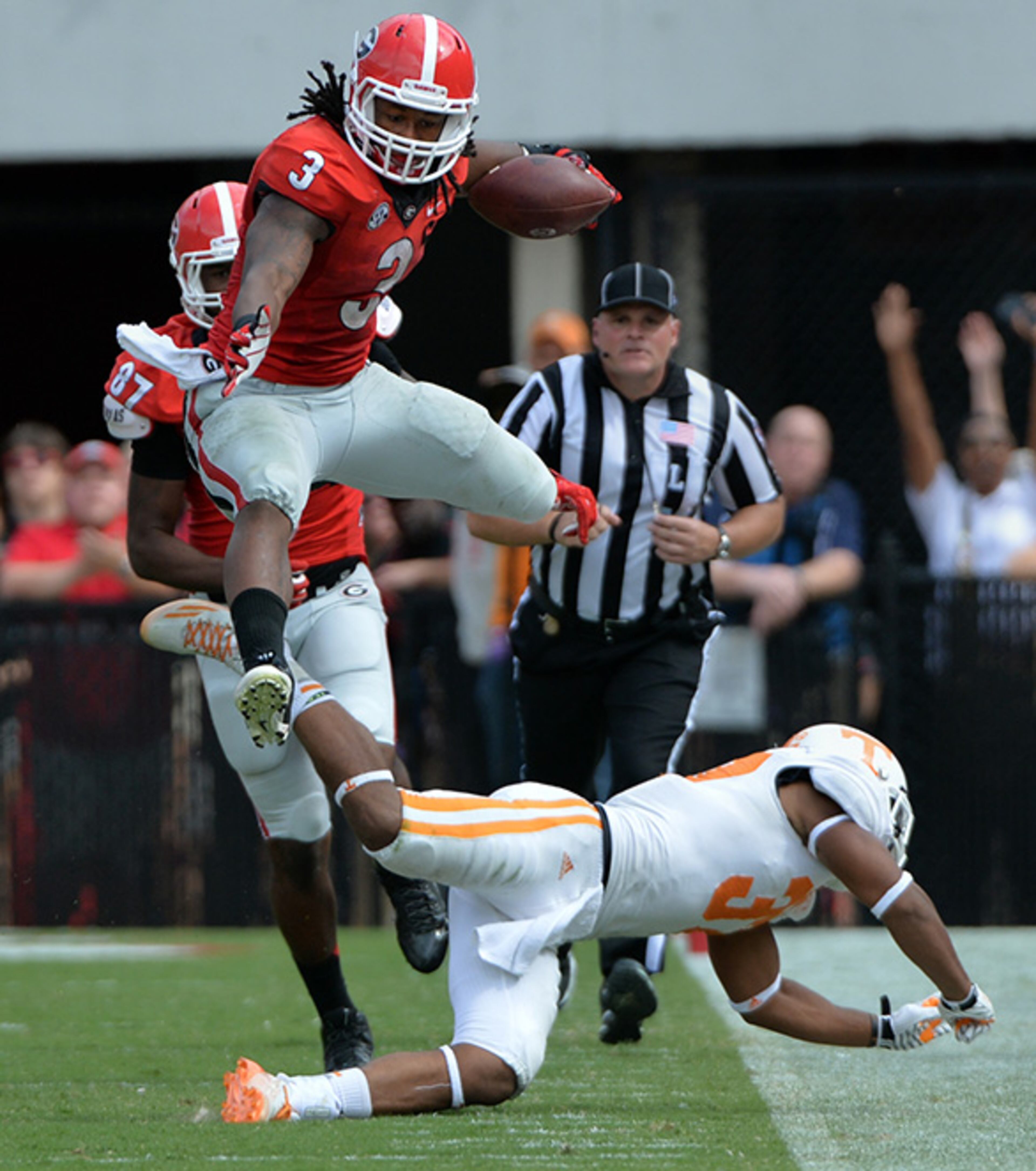 September 27, 2014 Athens, GA: Georgia Bulldogs running back Todd Gurley leaps over Tennessee Volunteers defensive back Brian Randolph during the 4th quarter at Sanford Stadium Saturday September 27, 2014. BRANT SANDERLIN / BSANDERLIN@AJC.COM