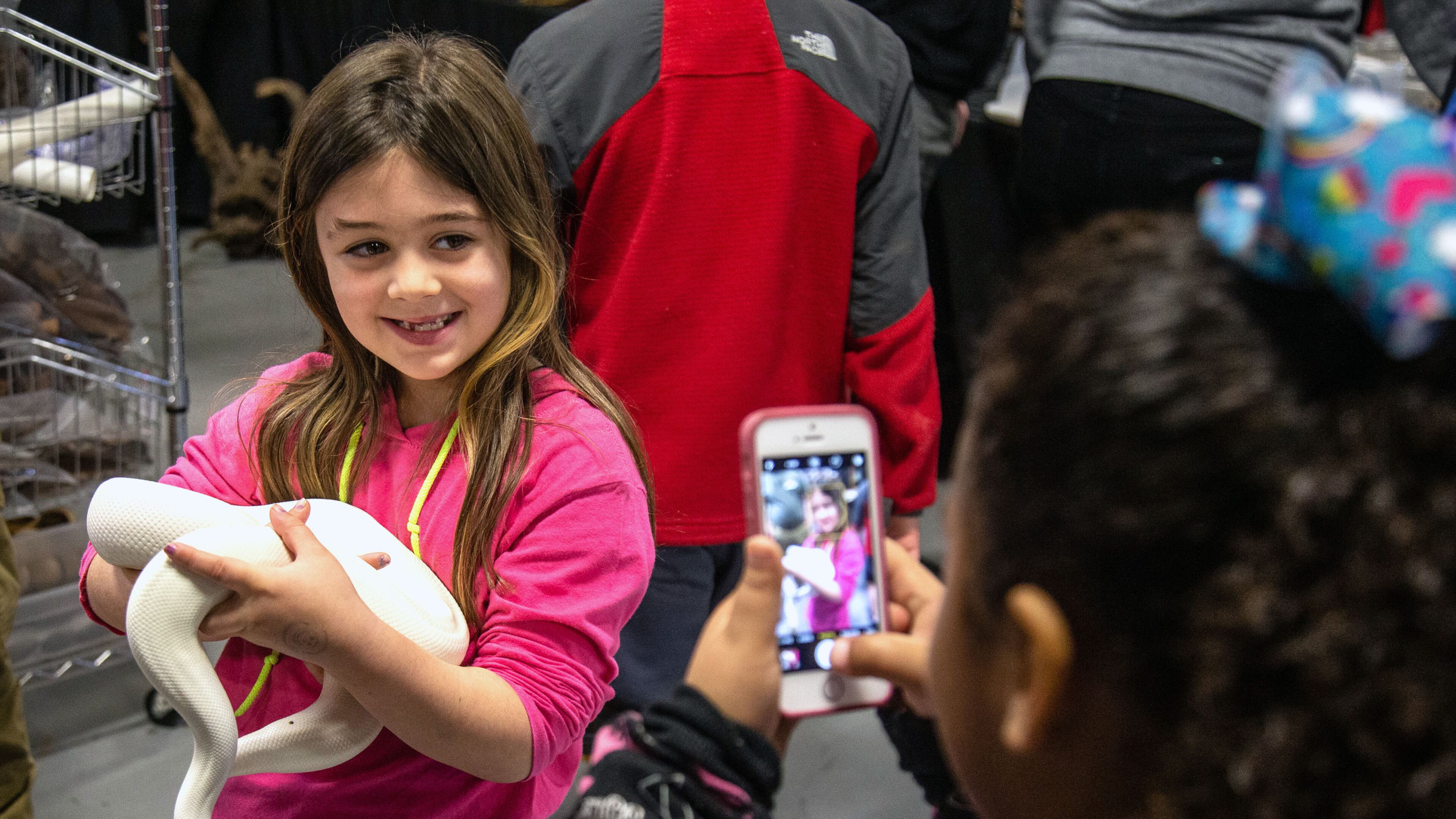 Sarah Folson poses for a photograph with a ball python during Repticon at the Gwinnett County Fairgrounds on Sunday, January 5, 2020. STEVE SCHAEFER / SPECIAL TO THE AJC