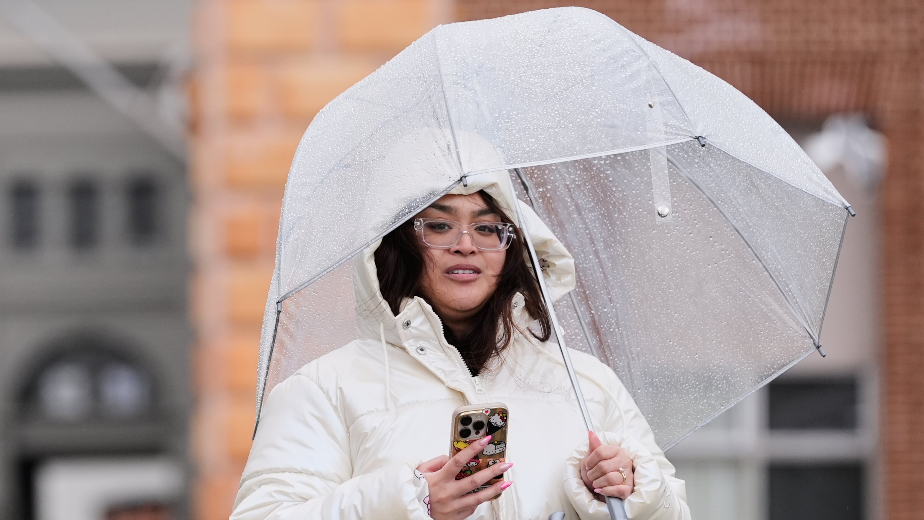 A woman walks in the rain, Tuesday, Feb. 17, 2026, in San Francisco. (AP Photo/Godofredo A. Vásquez)