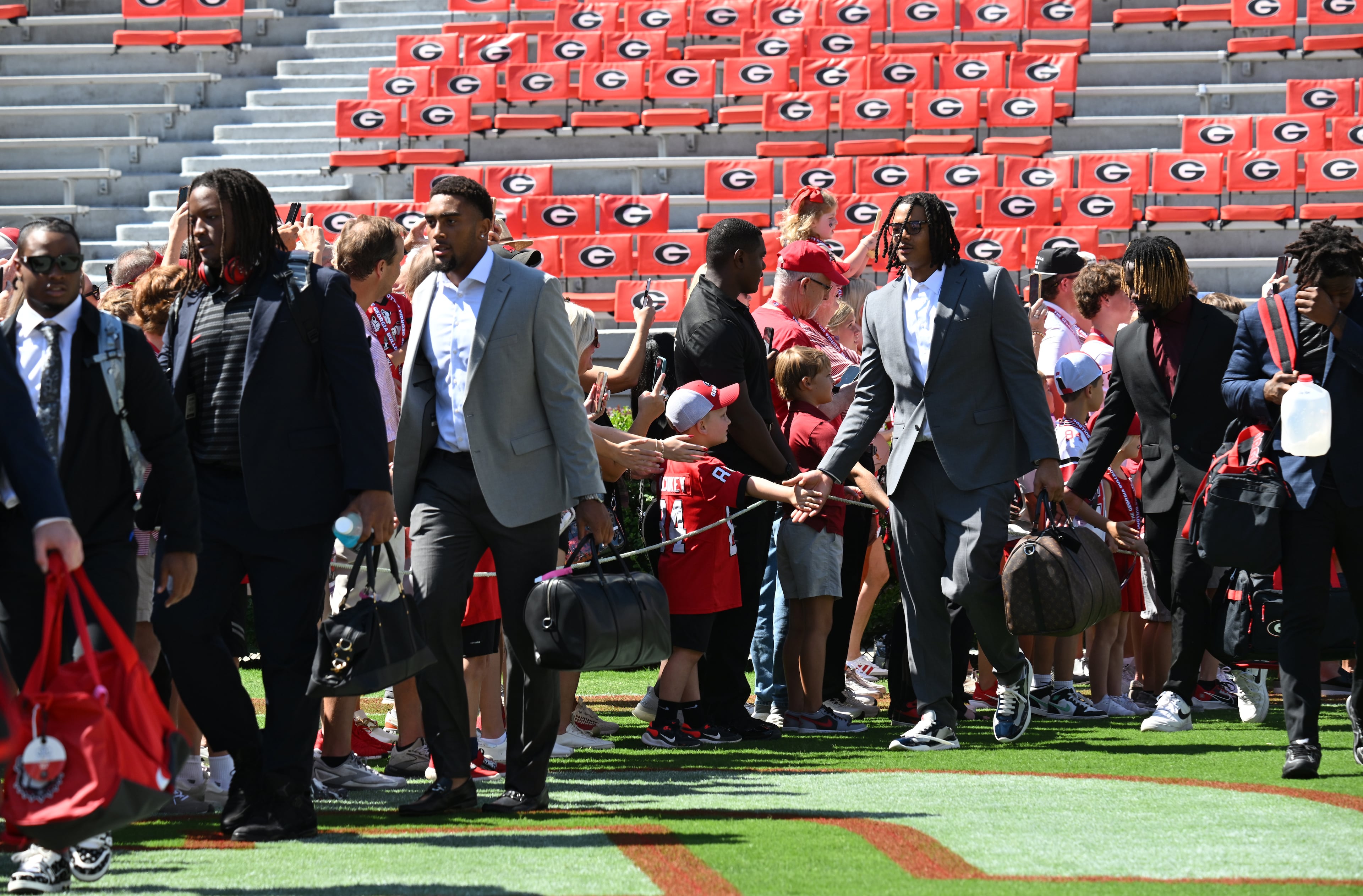 Georgia players greet fans during the Dawg Walk before before Georgia’s home opener against Tennessee Tech at Sanford Stadium, Saturday, September 9, 2024, in Athens. (Hyosub Shin / AJC)