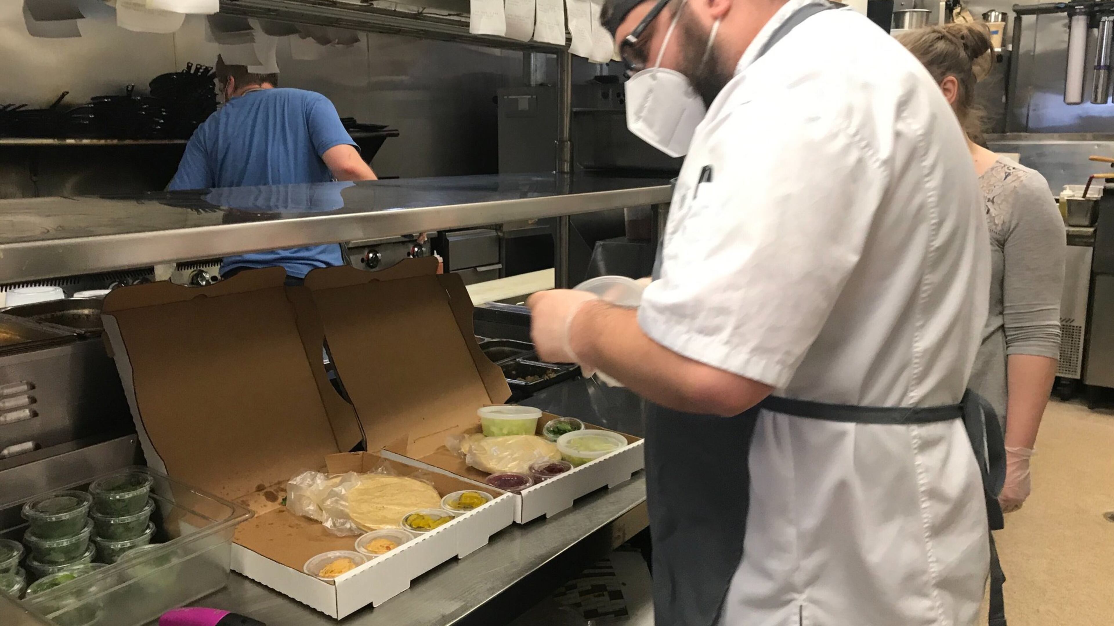Coalition Food and Beverage executive chef Dean Hill fills orders at sister restaurant Osteria Mattone. Ryan Pernice, who owns three restaurants, Table and Main and Osteria in Roswell and Coalition in Alpharetta, said he would delay returning to dine-in business. LIGAYA FIGUERAS/LIGAYA.FIGUERAS@AJC.COM