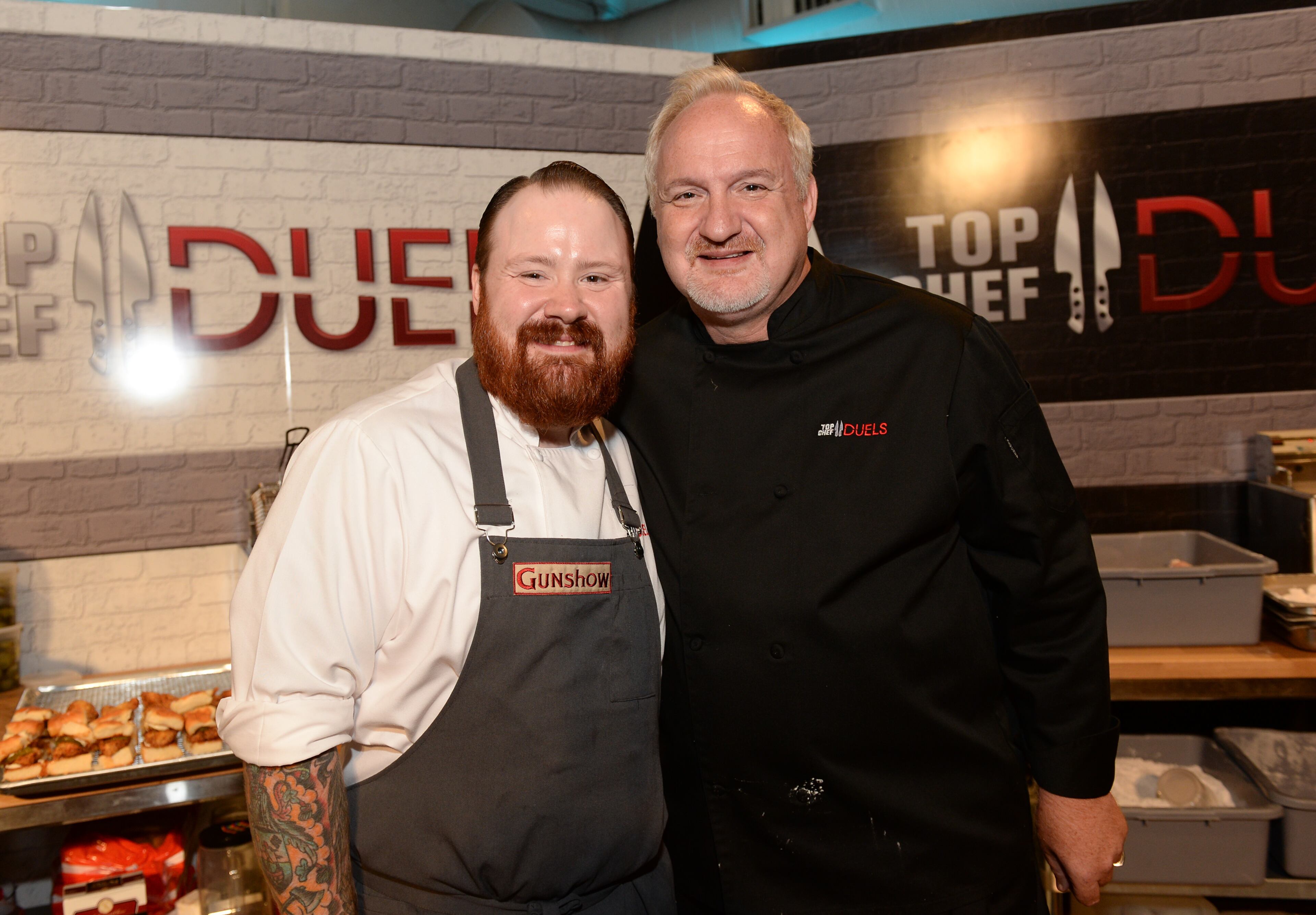 Chefs Kevin Gillespie, left, and Art Smith attend the "Top Chef Duels" Premiere Tasting Event, hosted by Chase Sapphire Preferred and Bravo, at the Altman Building, on Monday, Aug. 4, 2014 in New York. (Photo by Evan Agostini/Invision for Chase Sapphire Preferred/AP Images)