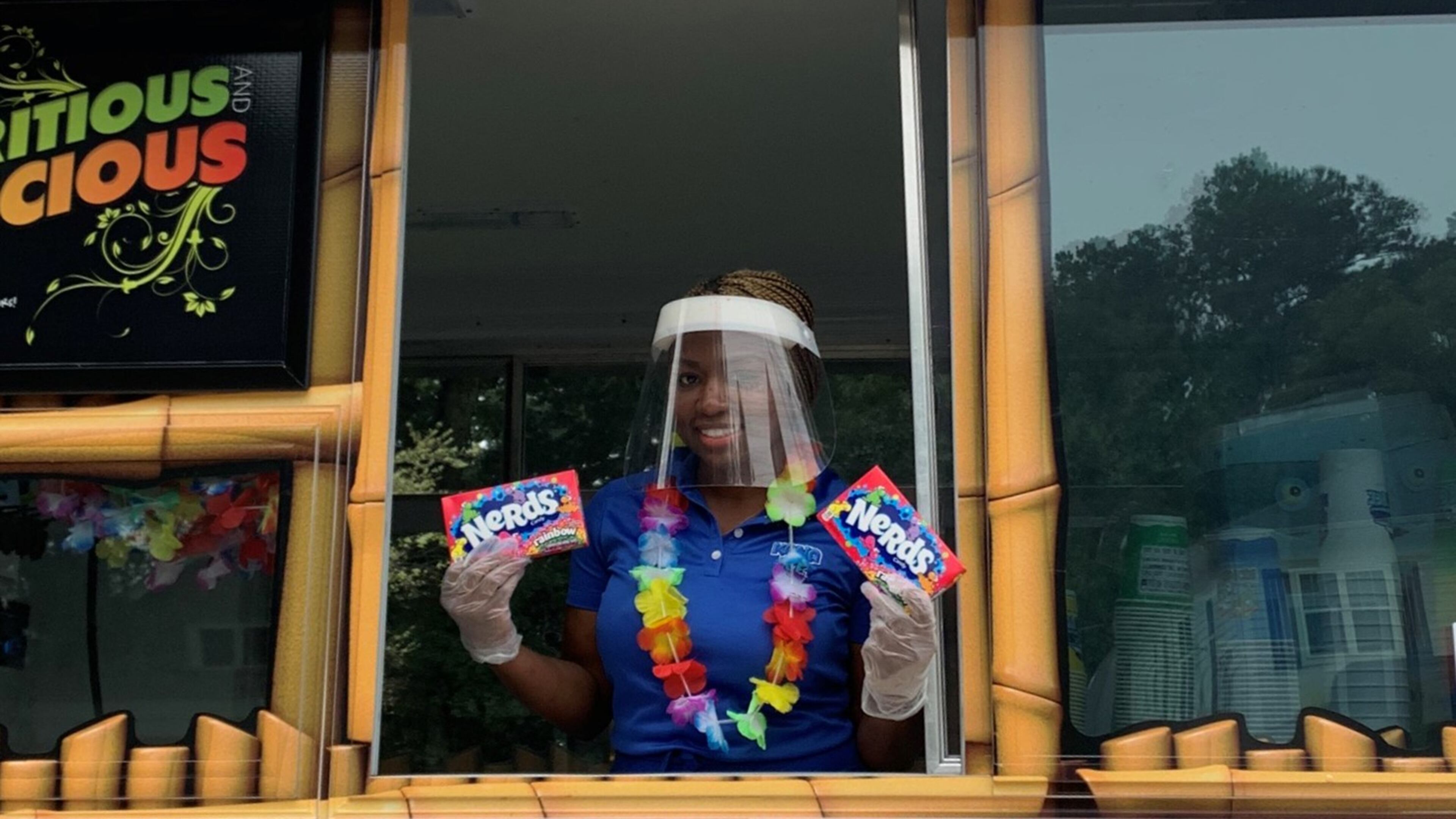 Quanesha Jackson, owner of Kona Ice of SW Atlanta prepares to serve icy treats to members of her community. Courtesy of Kona Ice of SW Atlanta