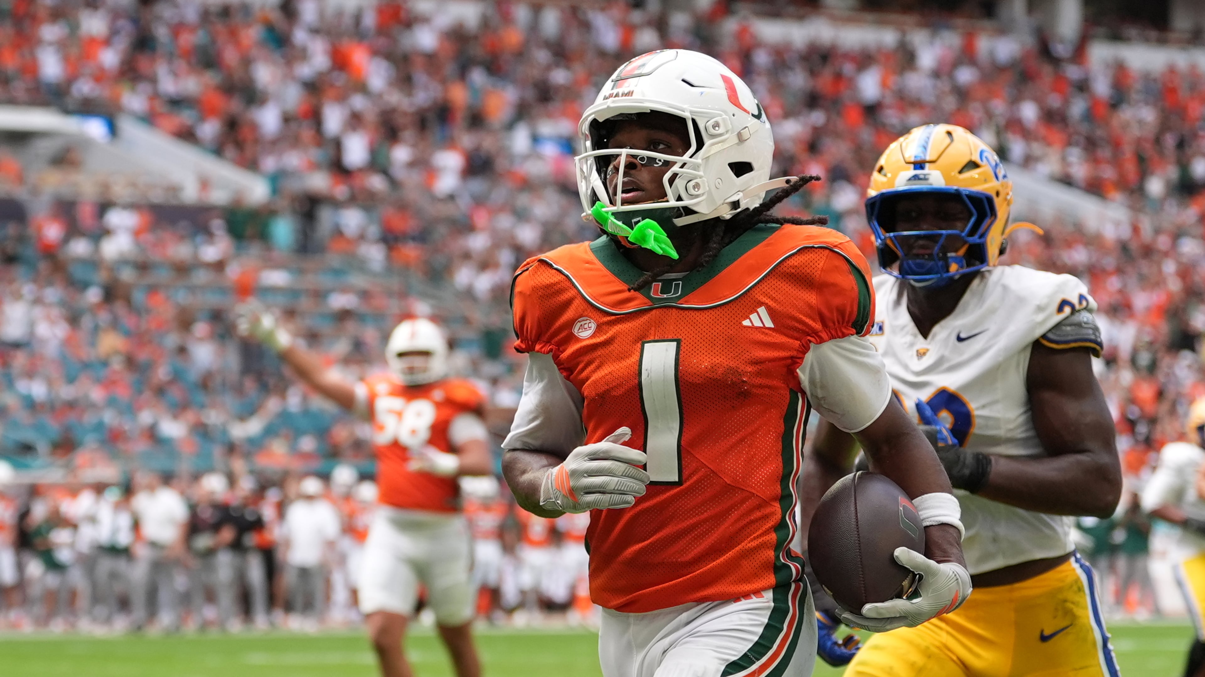 Miami wide receiver Malachi Toney (left) runs for a touchdown against Pittsburgh on Saturday, Oct. 24, 2026, in Miami Gardens, Florida. Toney had a school-record 16 receptions, as well as 194 receiving yards and three touchdowns. (Rebecca Blackwell/AP)