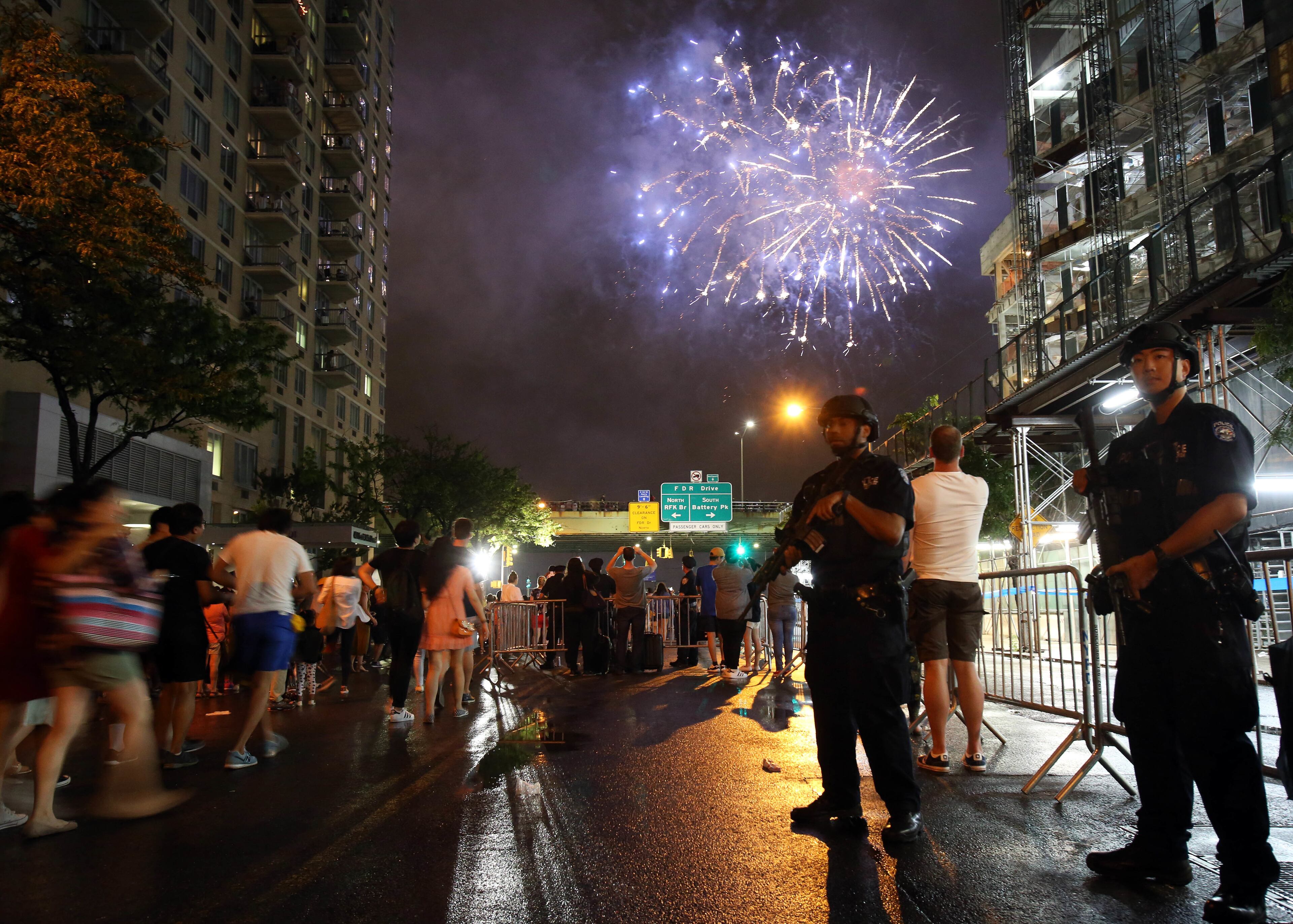 New York City counterterrorism police officers watch over spectators watching the Fourth of July Fireworks, Monday, July 4, 2016, along the East River on the FDR drive in New York. (AP Photo/Adam Hunger)