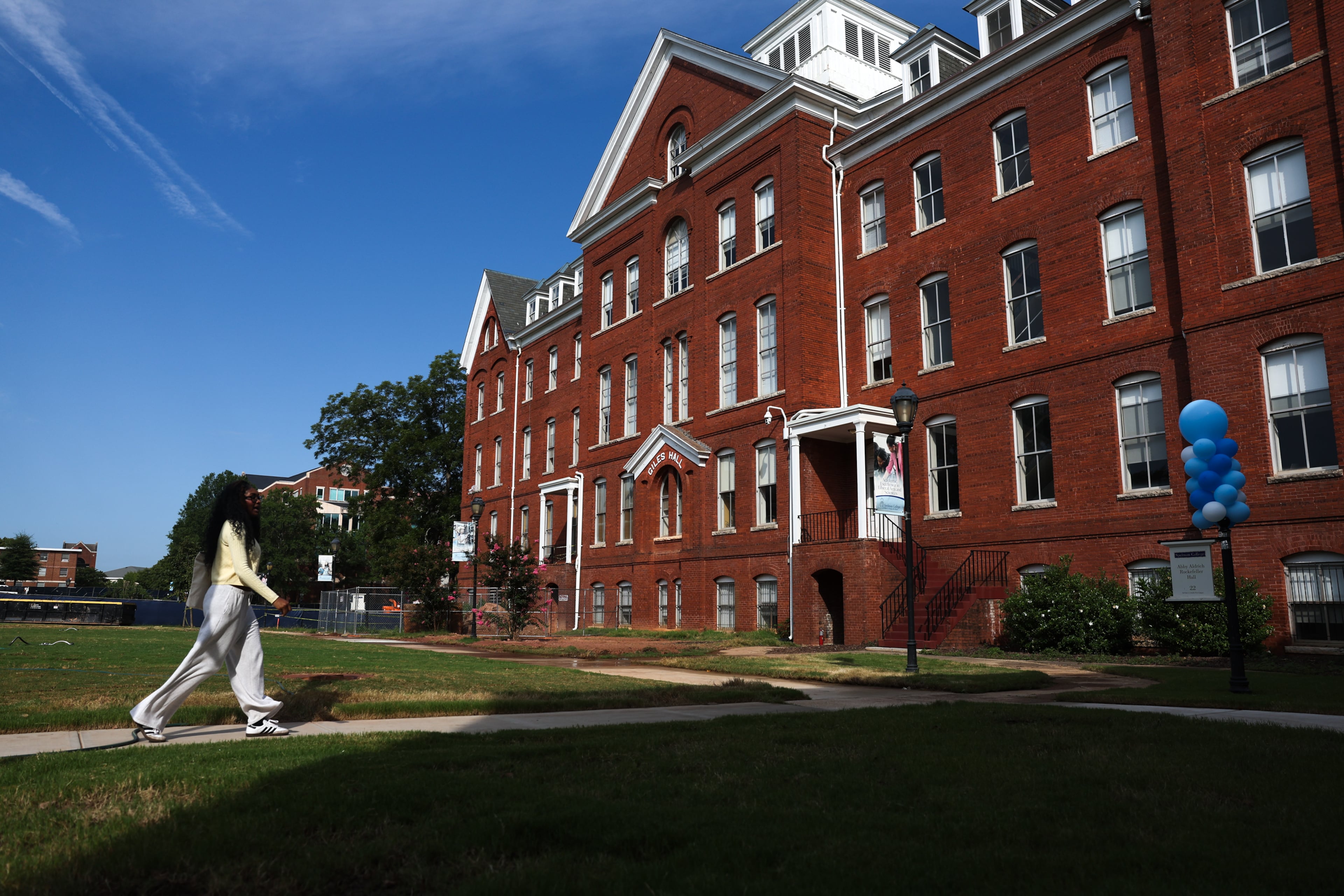 First-year student Alissa Seebaran walks by Giles Hall at Spelman College in Atlanta on Aug. 12, 2026. (Arvin Temkar/AJC)