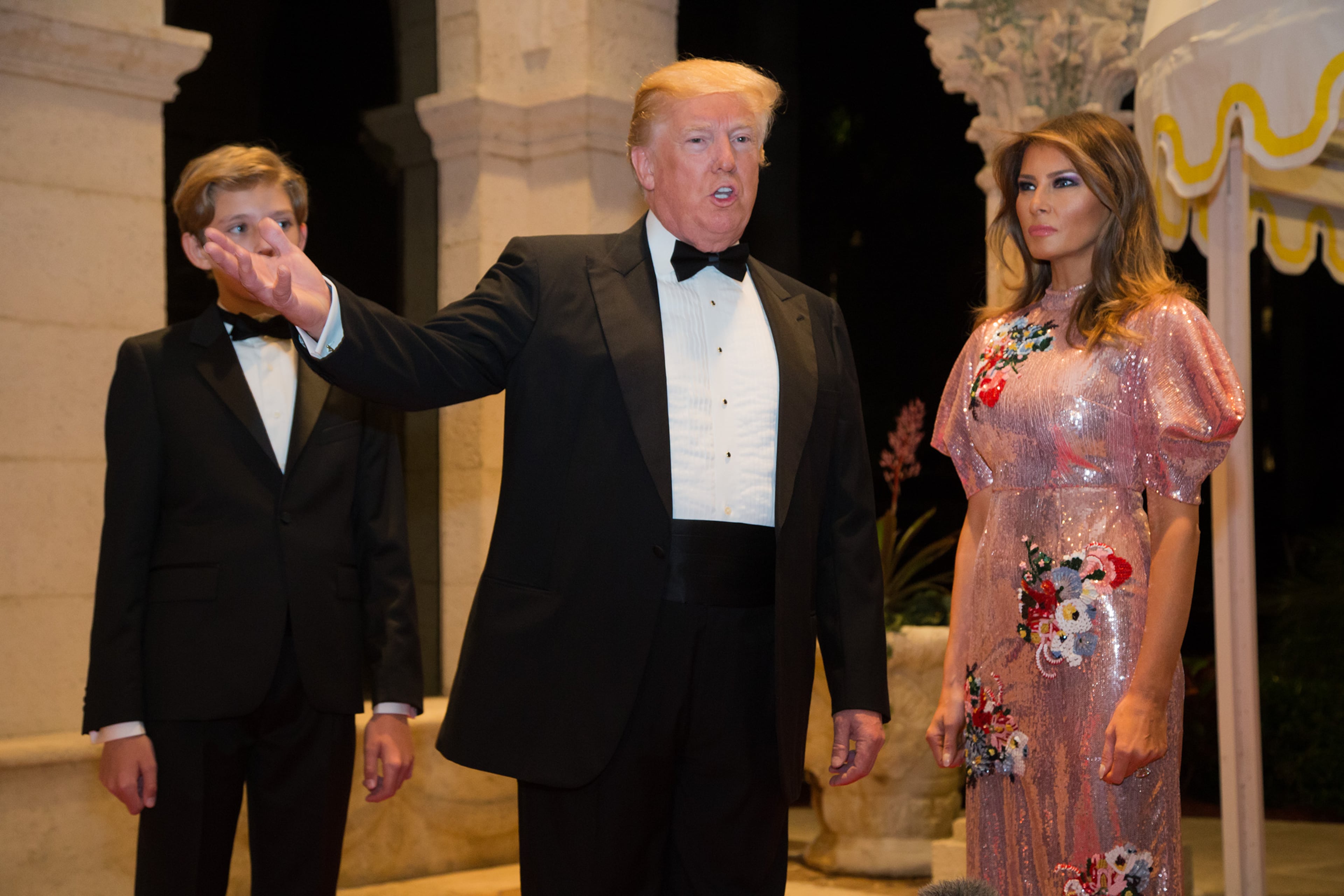 Barron Trump, left with his father, President Donald Trump and first lady Melania Trump walk the red carpet to the ballroom for the Mar-a-Lago New Year's Eva Gala at Mar-a-Lago in Palm Beach, Sun., December 31, 2017 in Palm Beach, Fla. (Greg Lovett / The Palm Beach Post)