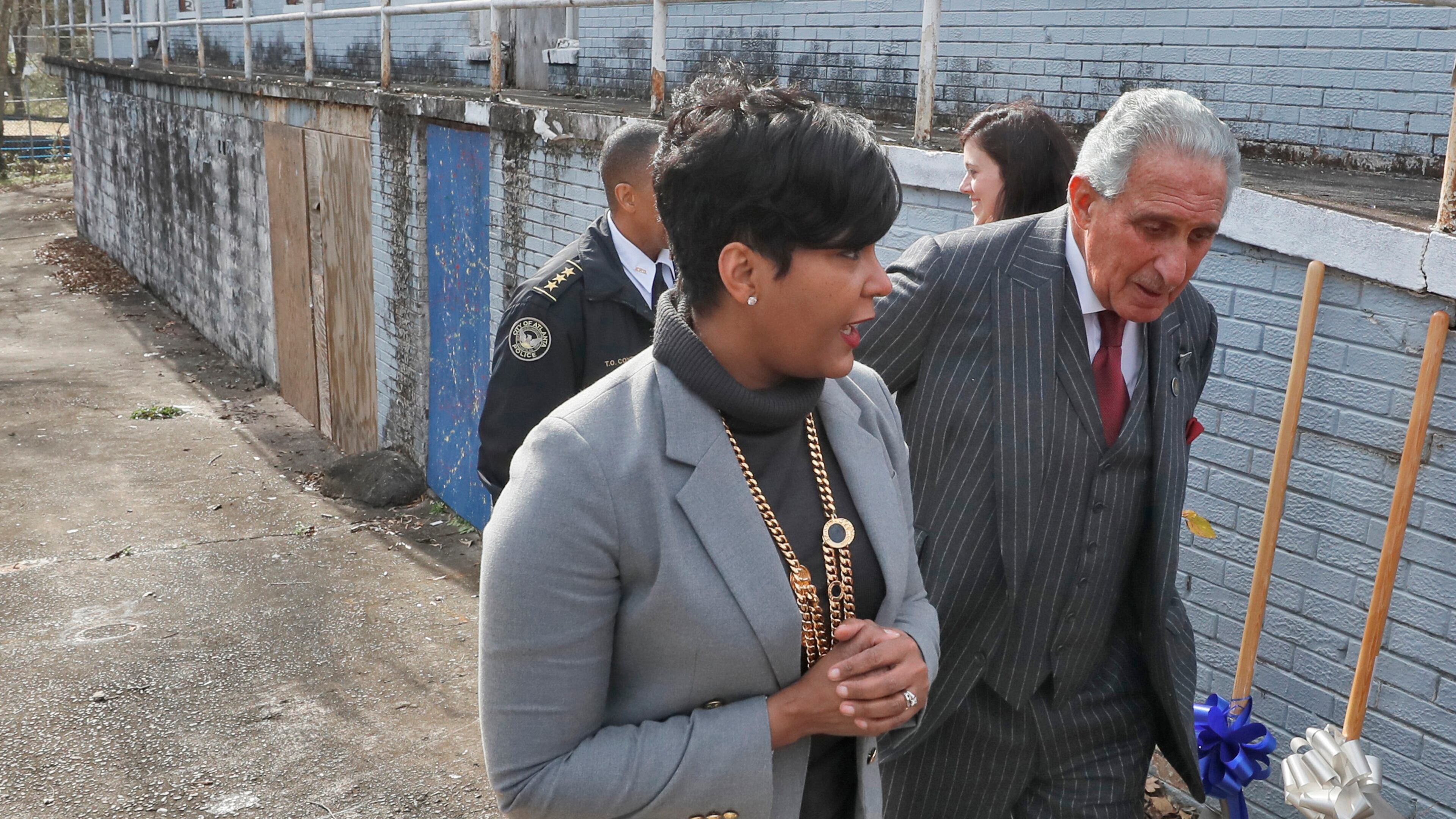January 9, 2020 - Atlanta - Mayor Keisha Lance Bottoms and Arthur Blank, Chair, Arthur M. Blank Family Foundation, walk by the abandoned apartments where the project will be built. They were among those to speak at the Atlanta Police Recruit Housing Ground Breaking Ceremony in English Avenue. Also present were Councilmember Andre Dickens, Todd Coyt, Assistant Chief of Atlanta Police, and Dave Wilkinson, President & CEO, Atlanta Police Foundation. Bob Andres / bandres@ajc.com
