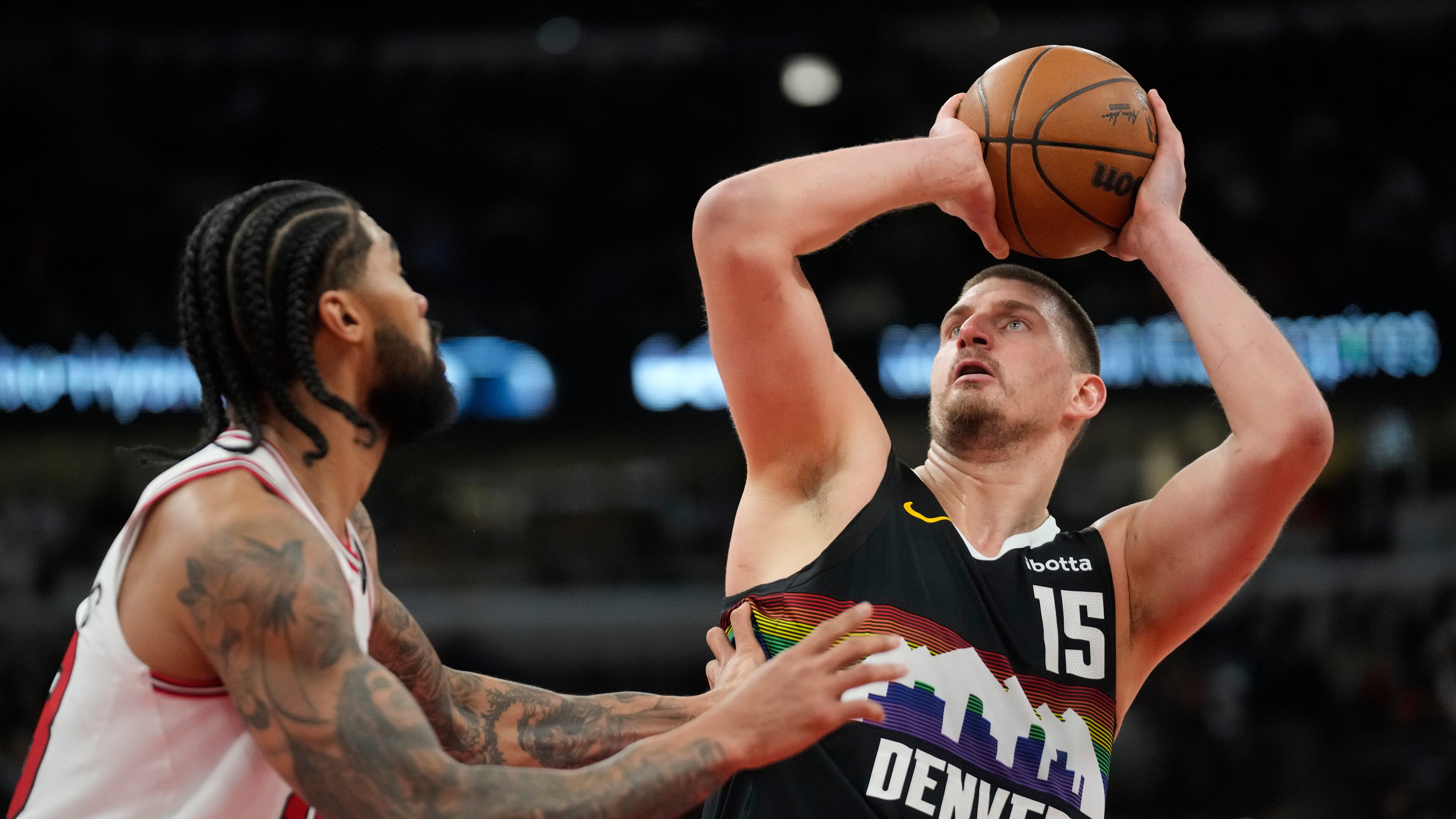 Denver Nuggets center Nikola Jokic (15), right, handles the ball as Chicago Bulls center Nick Richards (13) defends during the second half of an NBA basketball game Saturday, Feb. 7, 2026, in Chicago. (AP Photo/Erin Hooley)