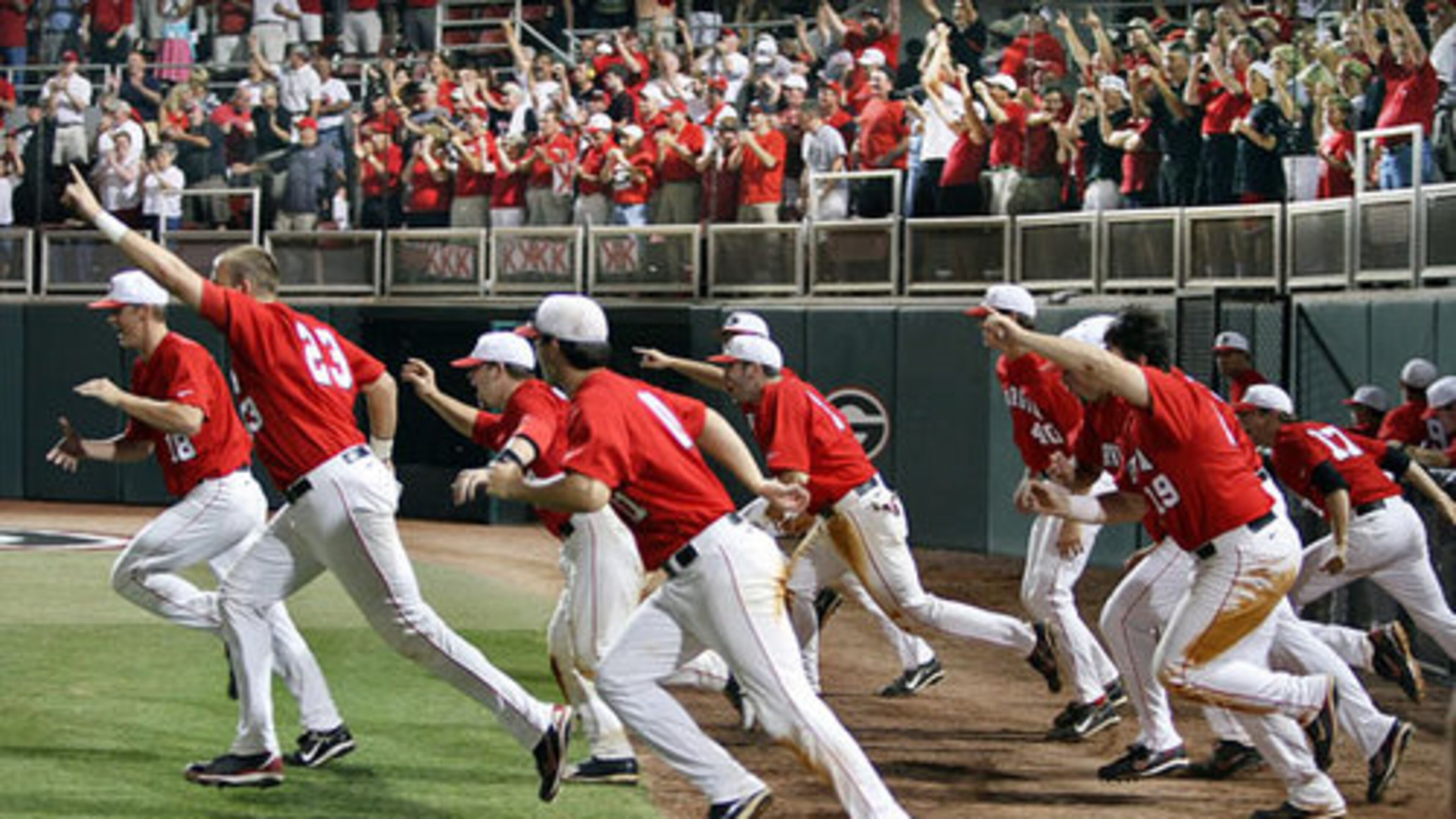 The Bulldogs charge the field to celebrate their 18-6 victory over rival Georgia Tech in their NCAA regional championship game at Foley Field in Athens on Monday.